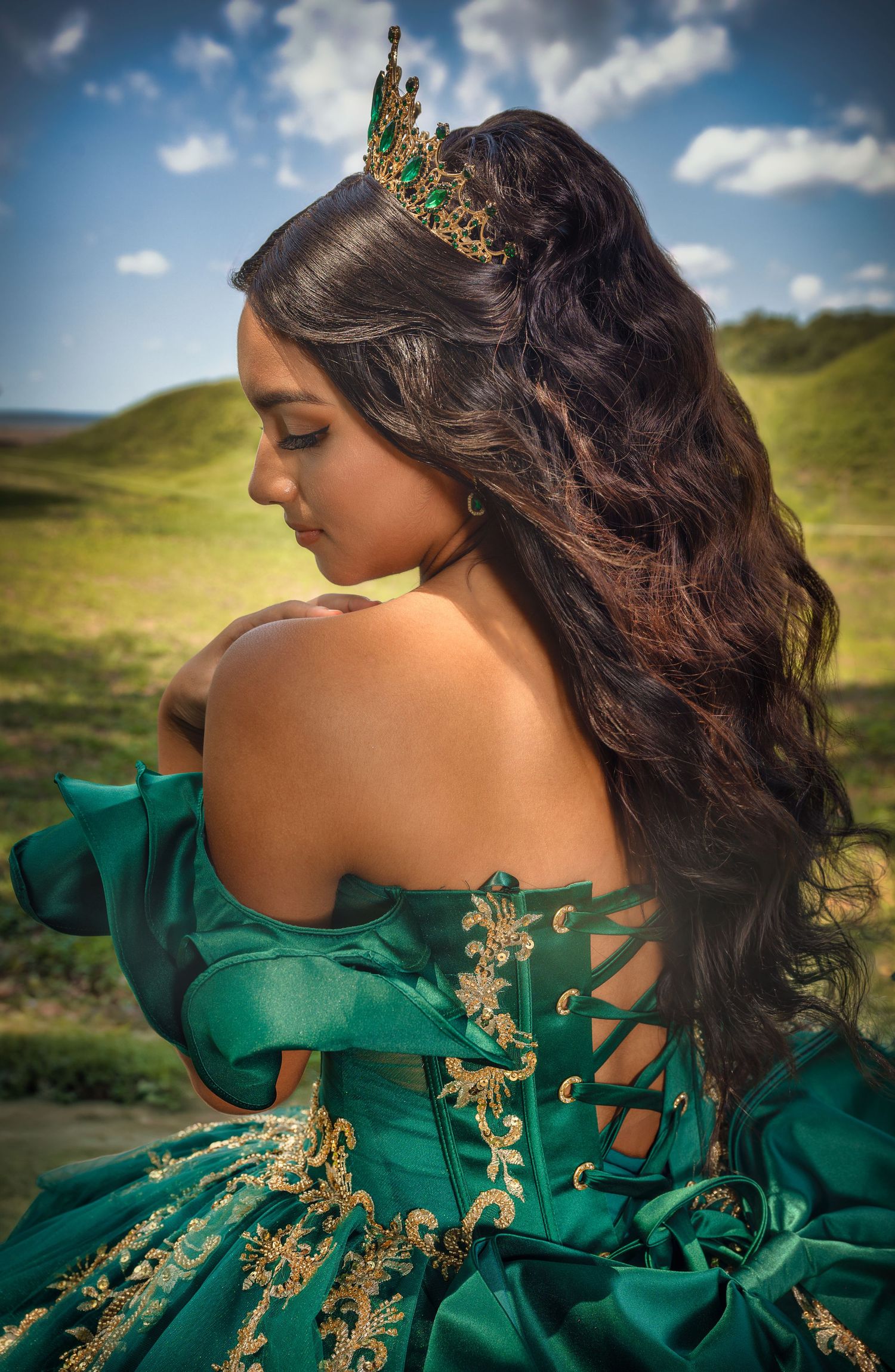 Editorial portrait featuring an emerald green formal gown