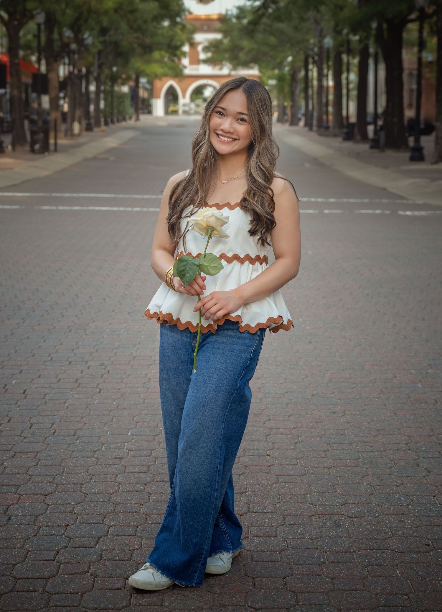 Outdoor senior portrait on a tree-lined street