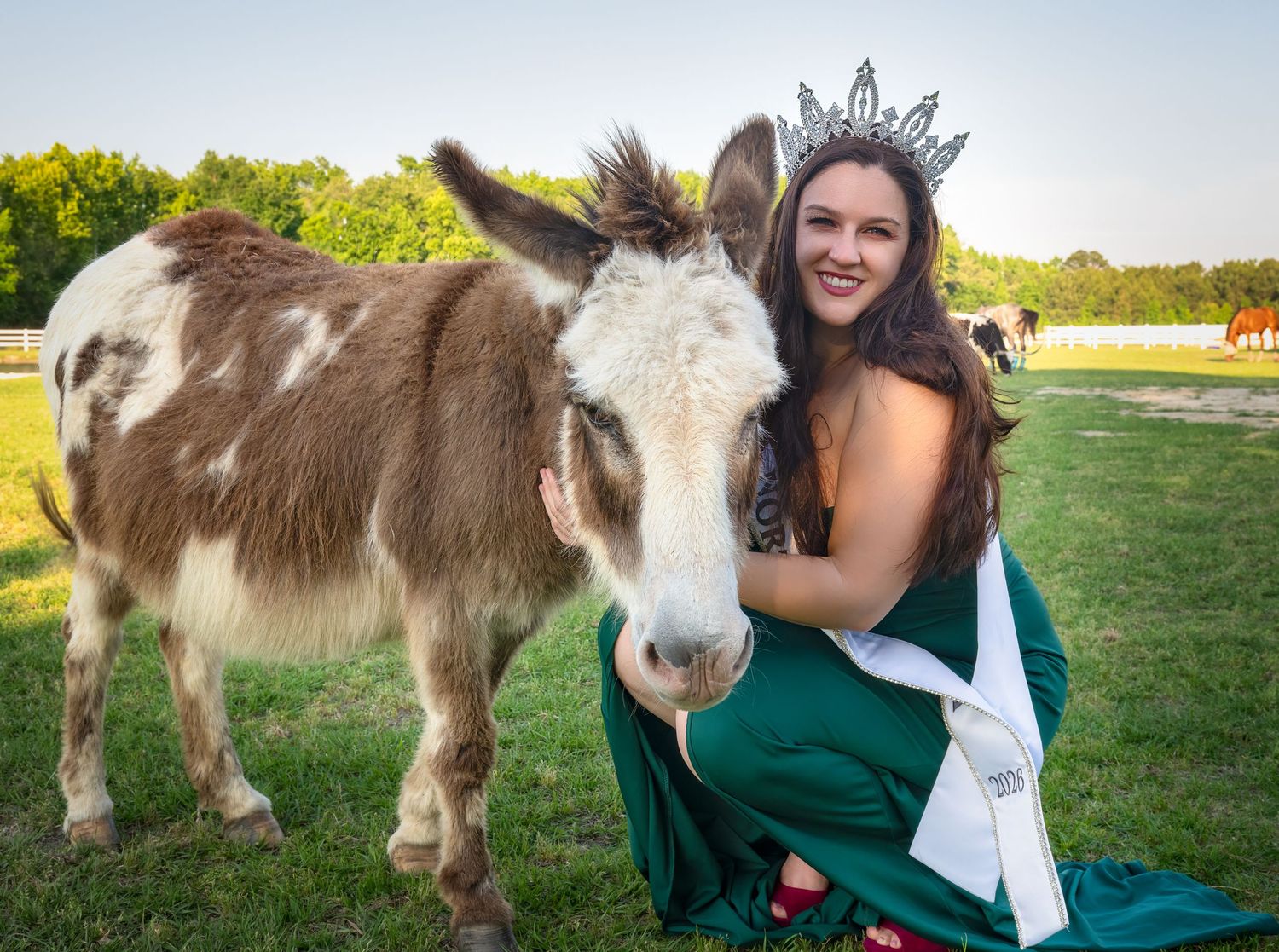 Outdoor pageant portrait in a green gown and crown