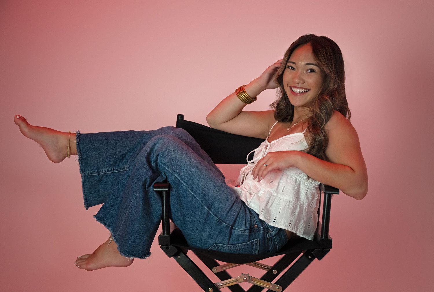 Creative studio portrait against a pink background