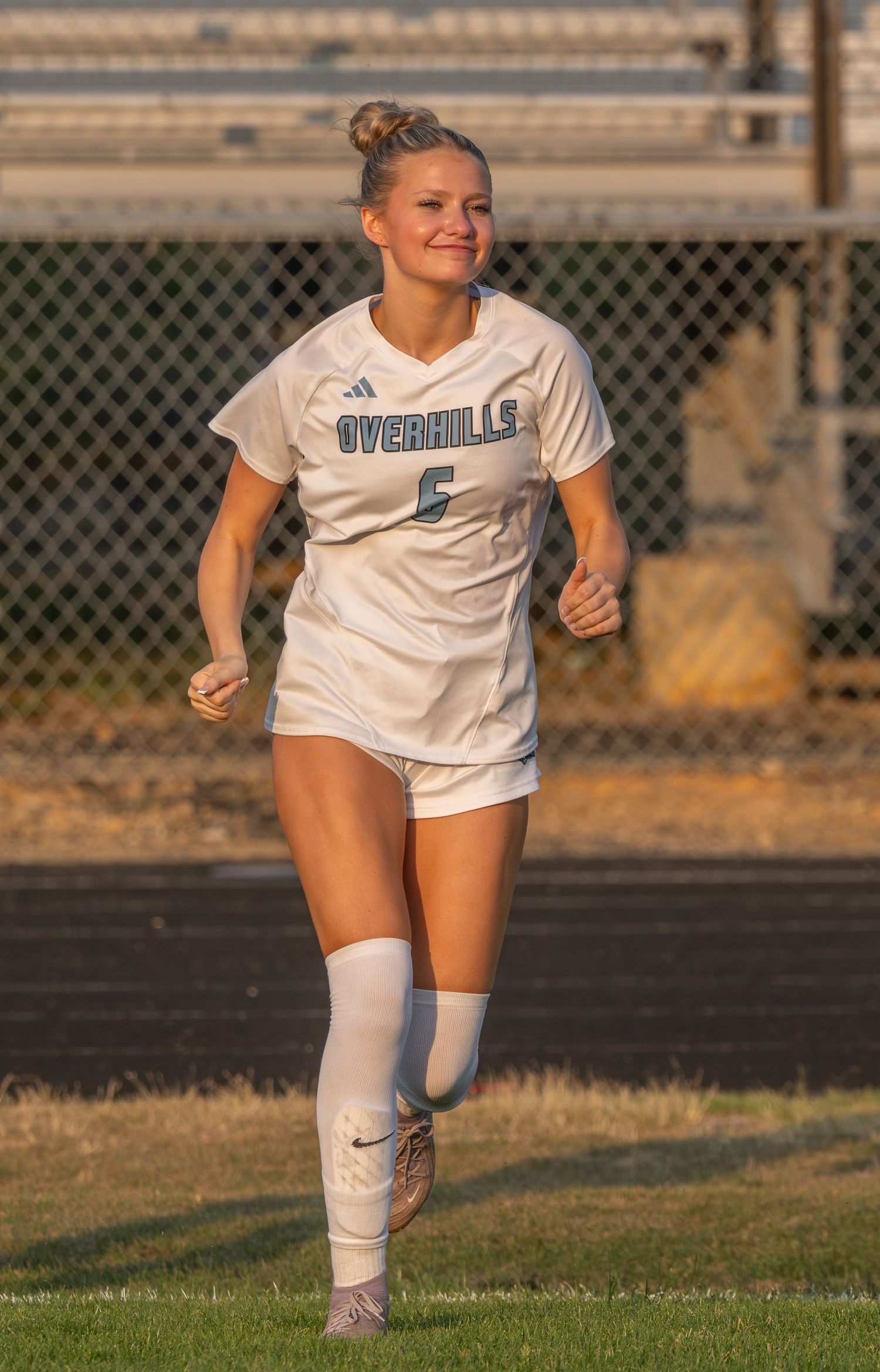 High school girls soccer player running during a game