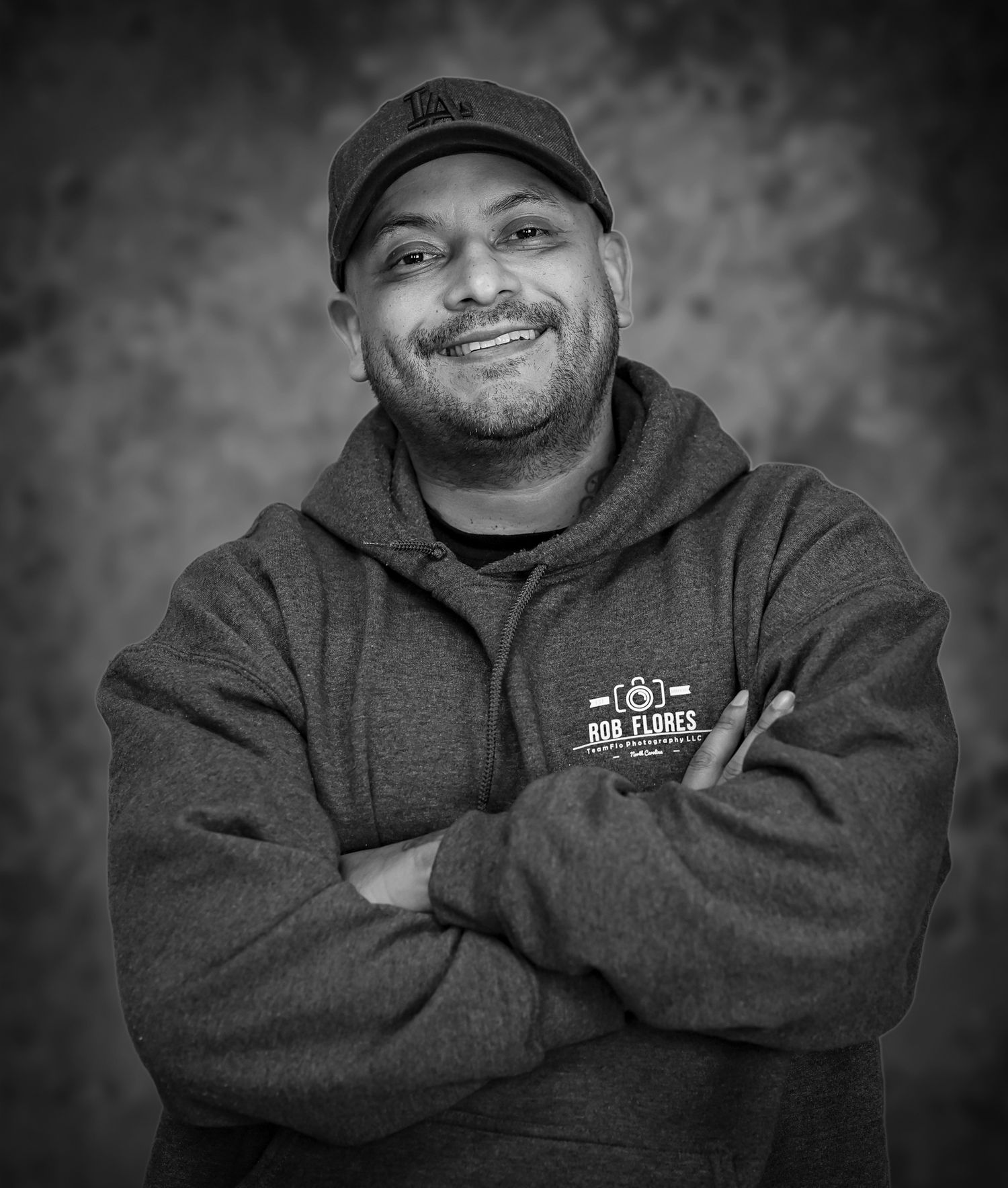 Black and white professional portrait of a man with arms crossed