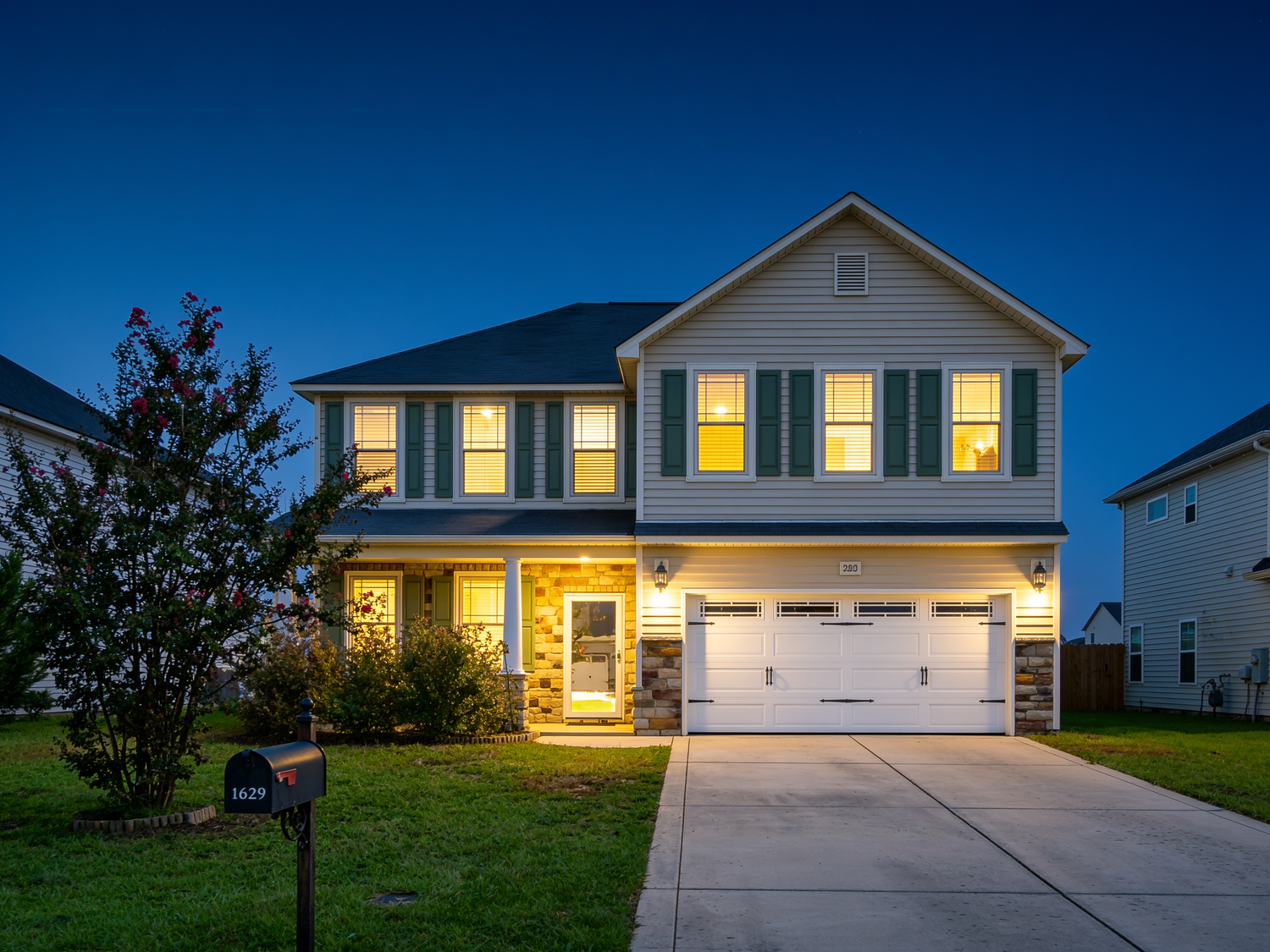Twilight exterior real estate photograph of a two-story home