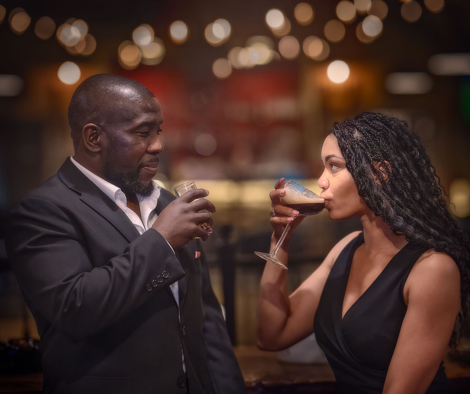 Formal event portrait of a couple raising glasses together