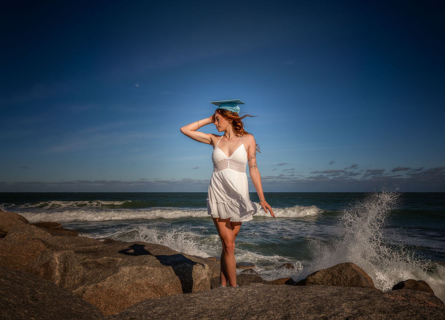Outdoor portrait in a white dress beside the ocean