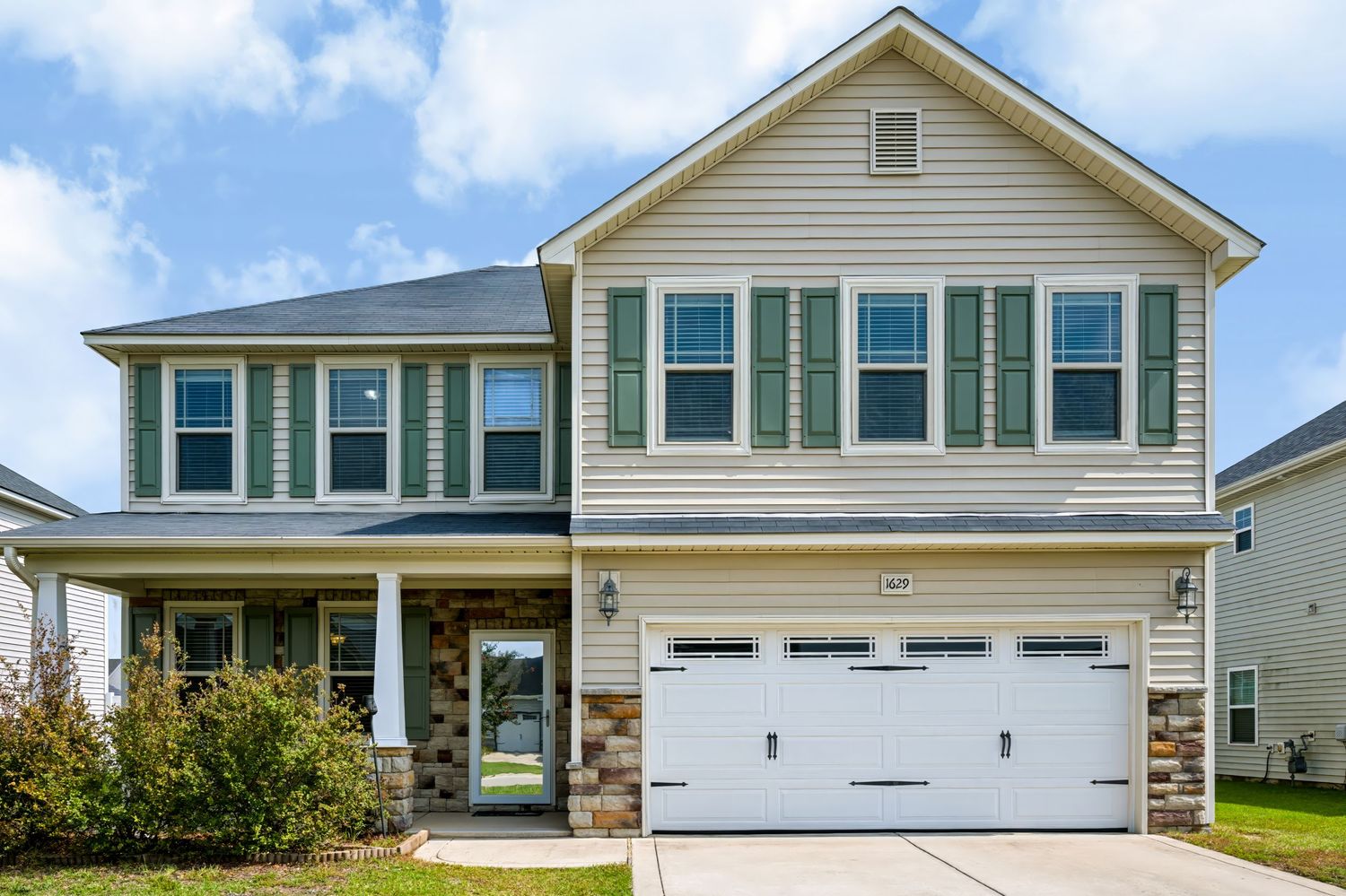 Professional exterior real estate photograph of a two-story home