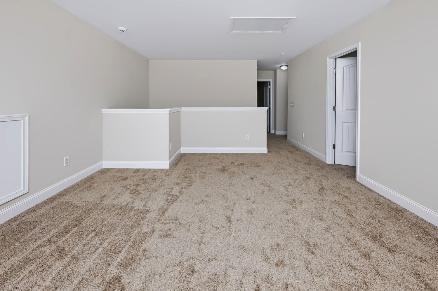 Real estate photograph of an empty bonus room