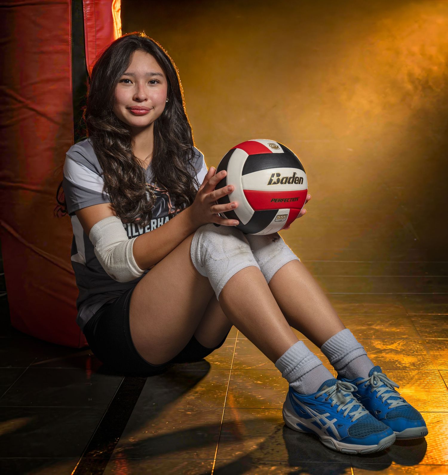 High school volleyball media day portrait holding a volleyball
