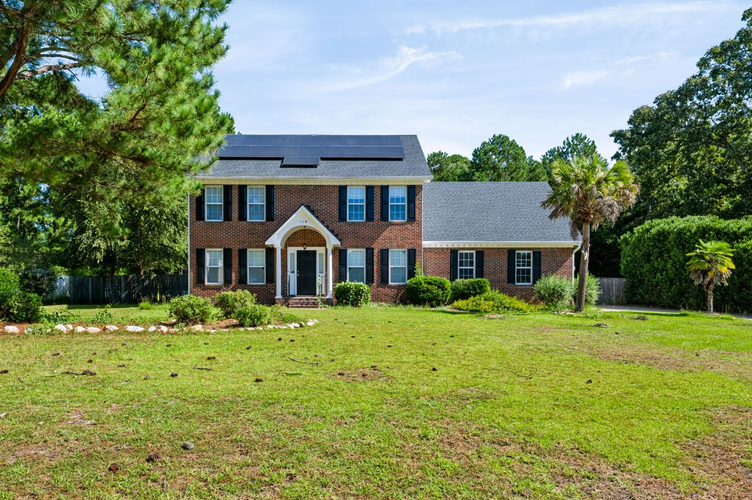 Exterior real estate photograph of a two-story brick home