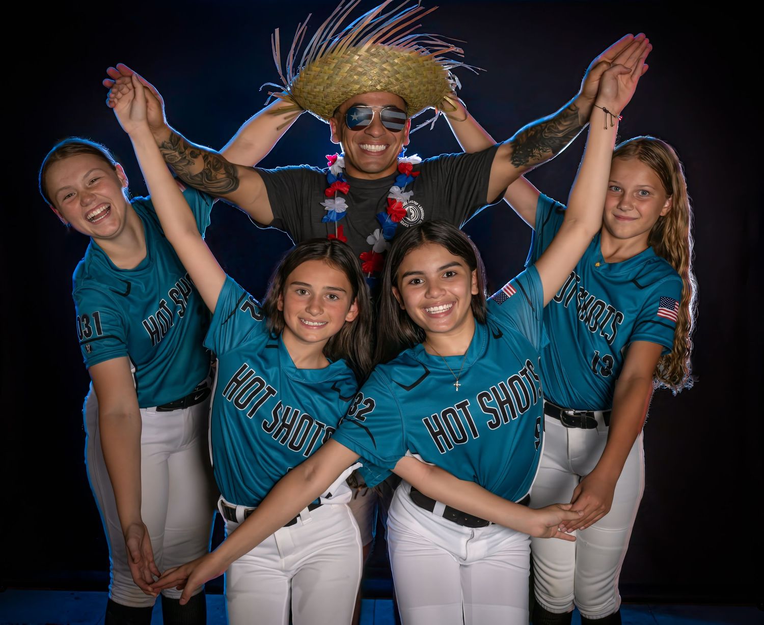 Softball team media day group portrait against a dark background