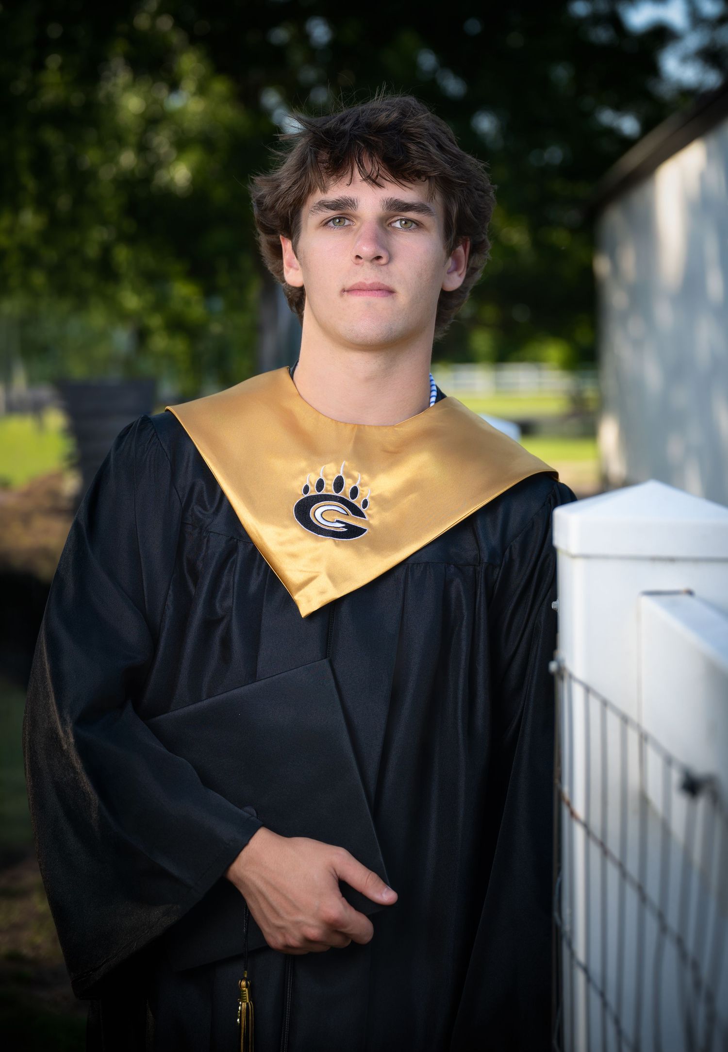 High school senior graduation portrait wearing cap and gown