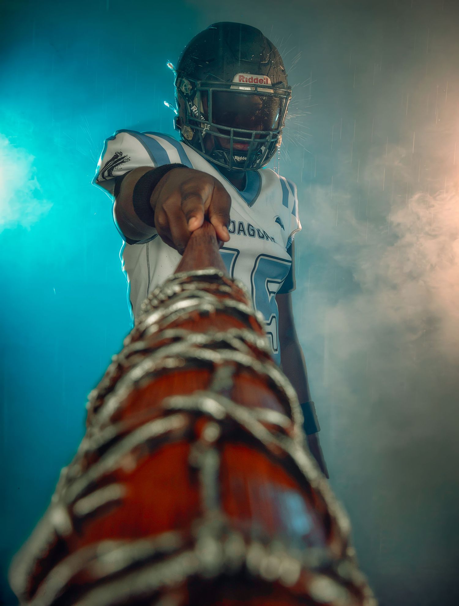 Creative high school football media day portrait with dramatic lighting