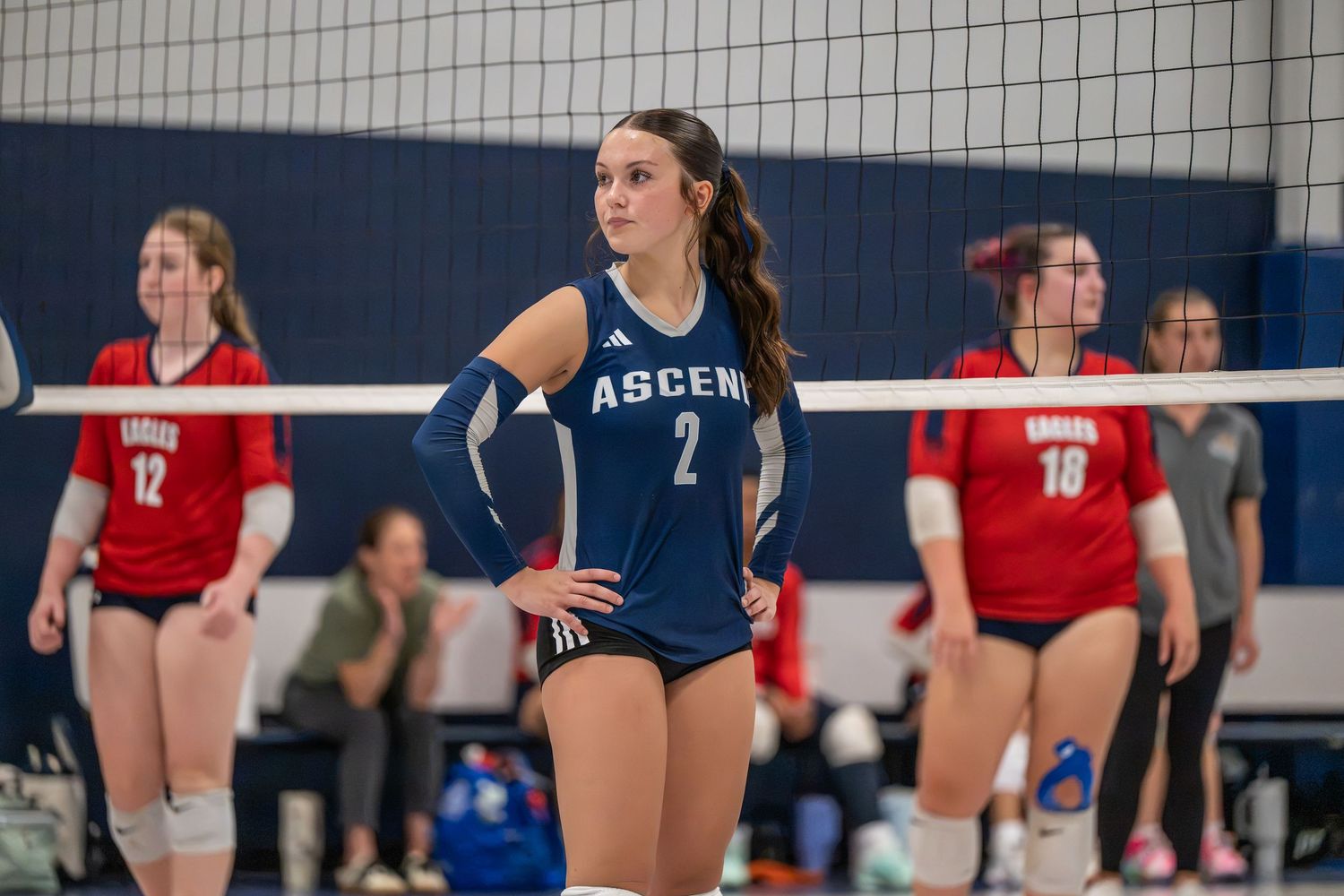 High school volleyball player on the court during a match