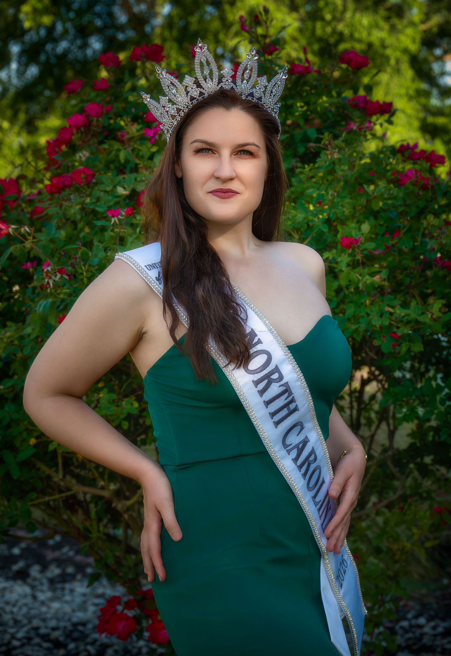 Outdoor pageant portrait in a green gown and sash
