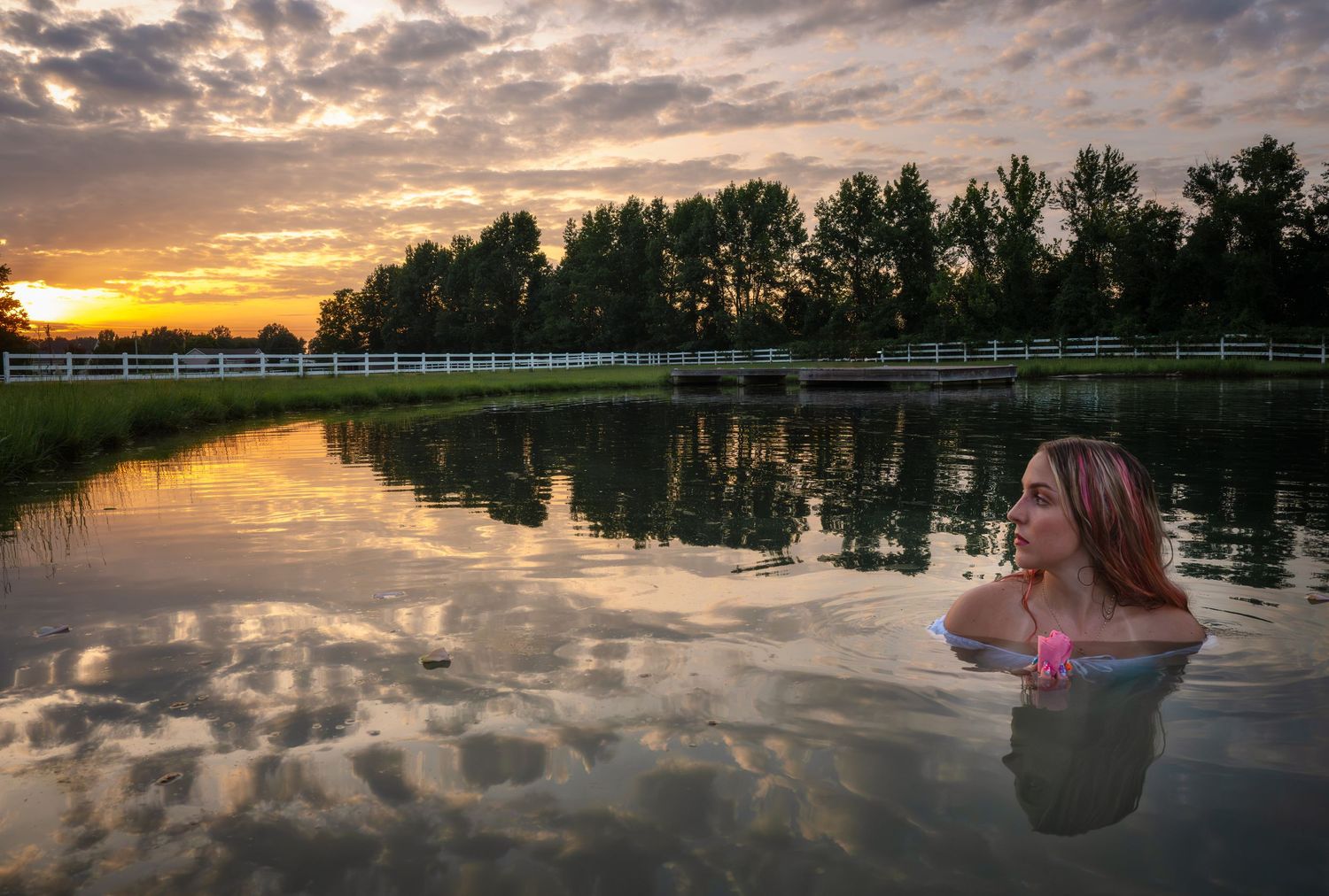 Creative outdoor portrait photographed in a lake at sunset