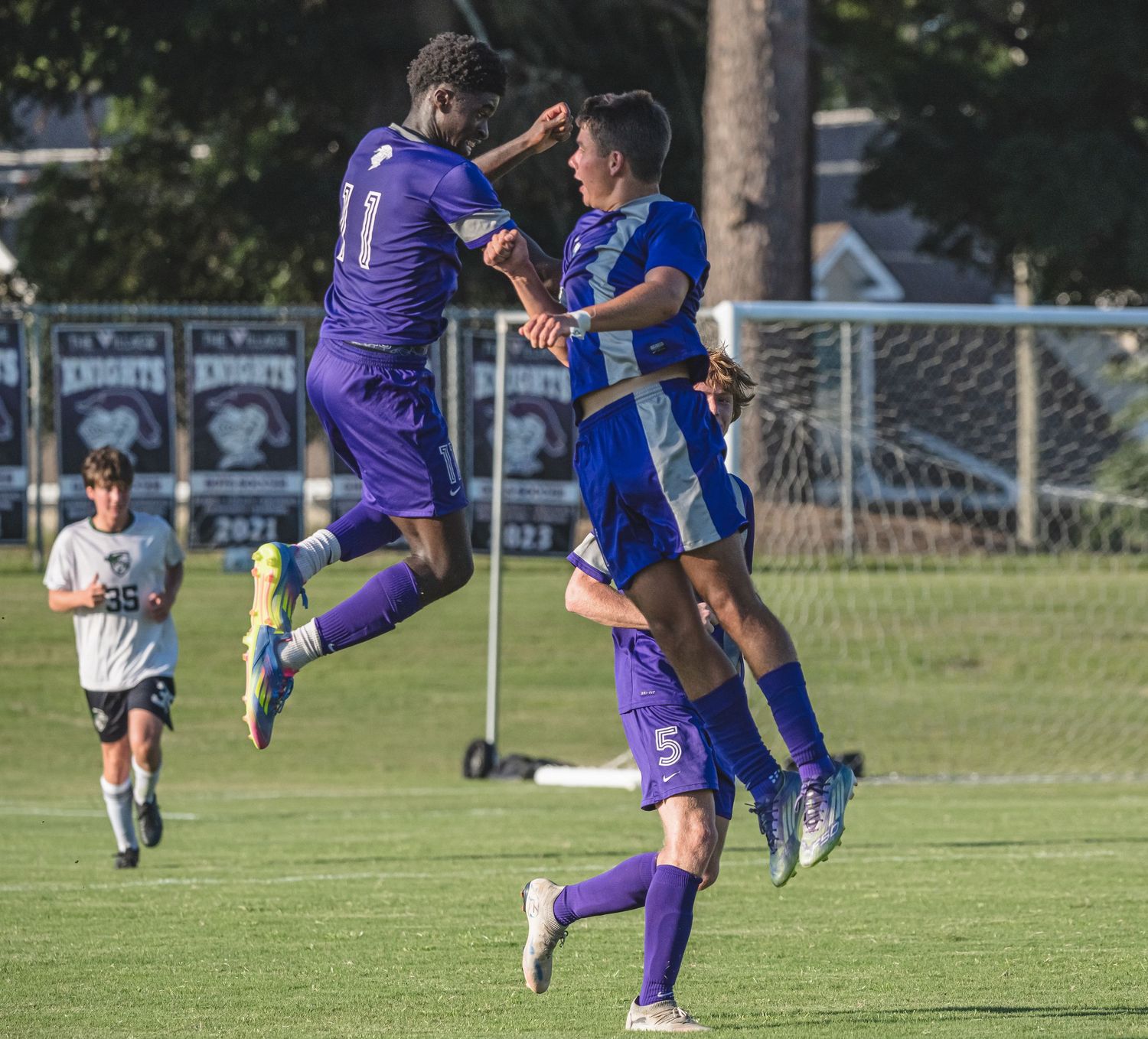 High school boys soccer players celebrating together during a game