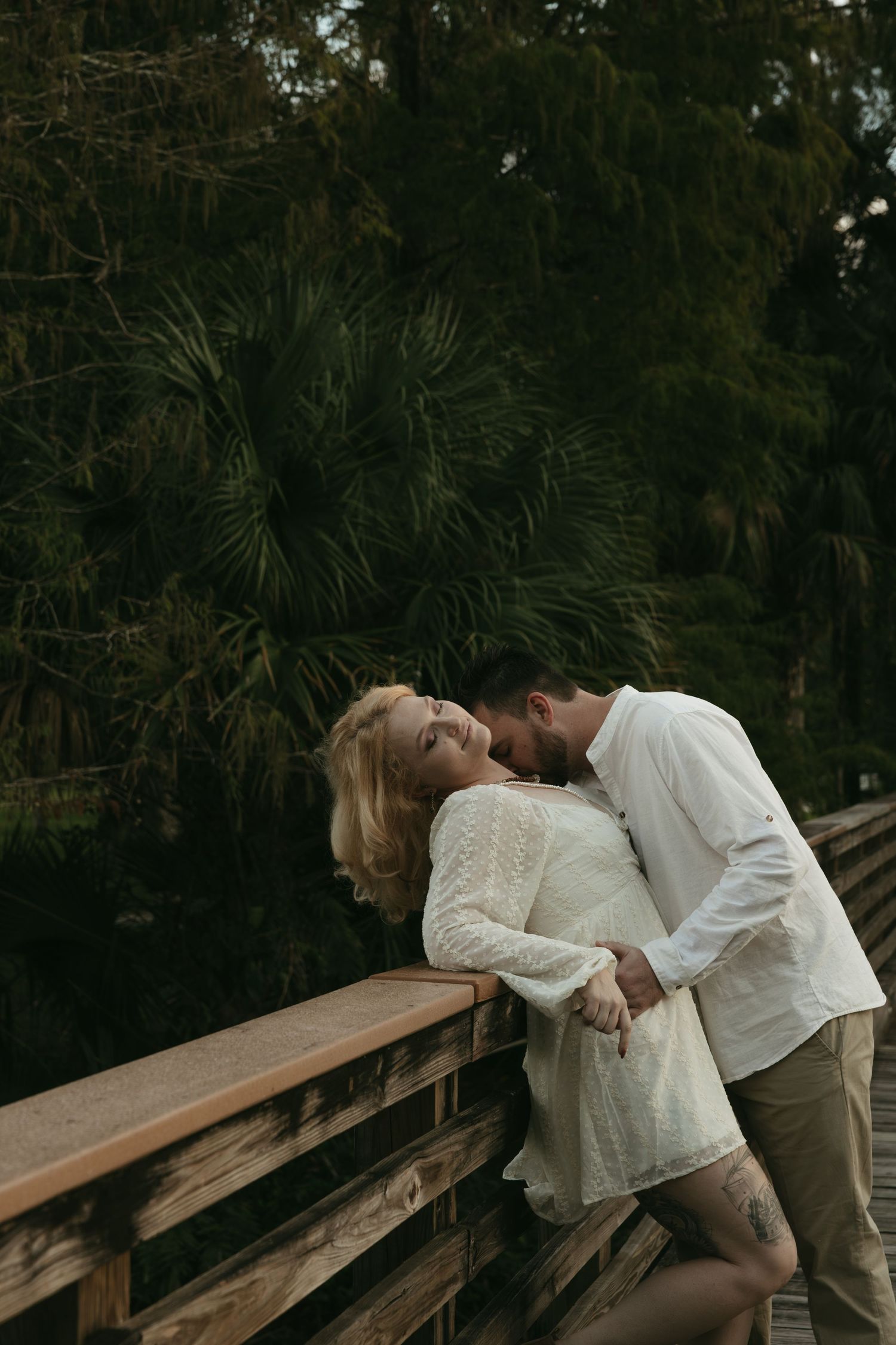 Couple getting cozy on bridge in jupiter florida