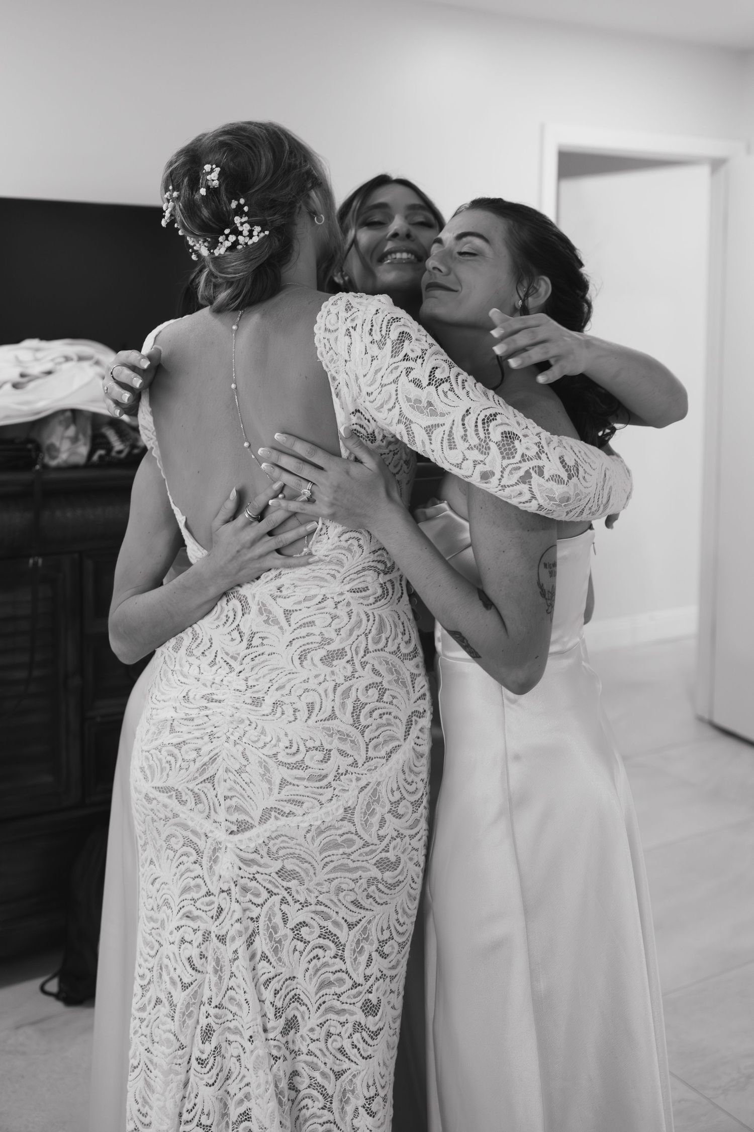 Bride hugging best friends at wedding