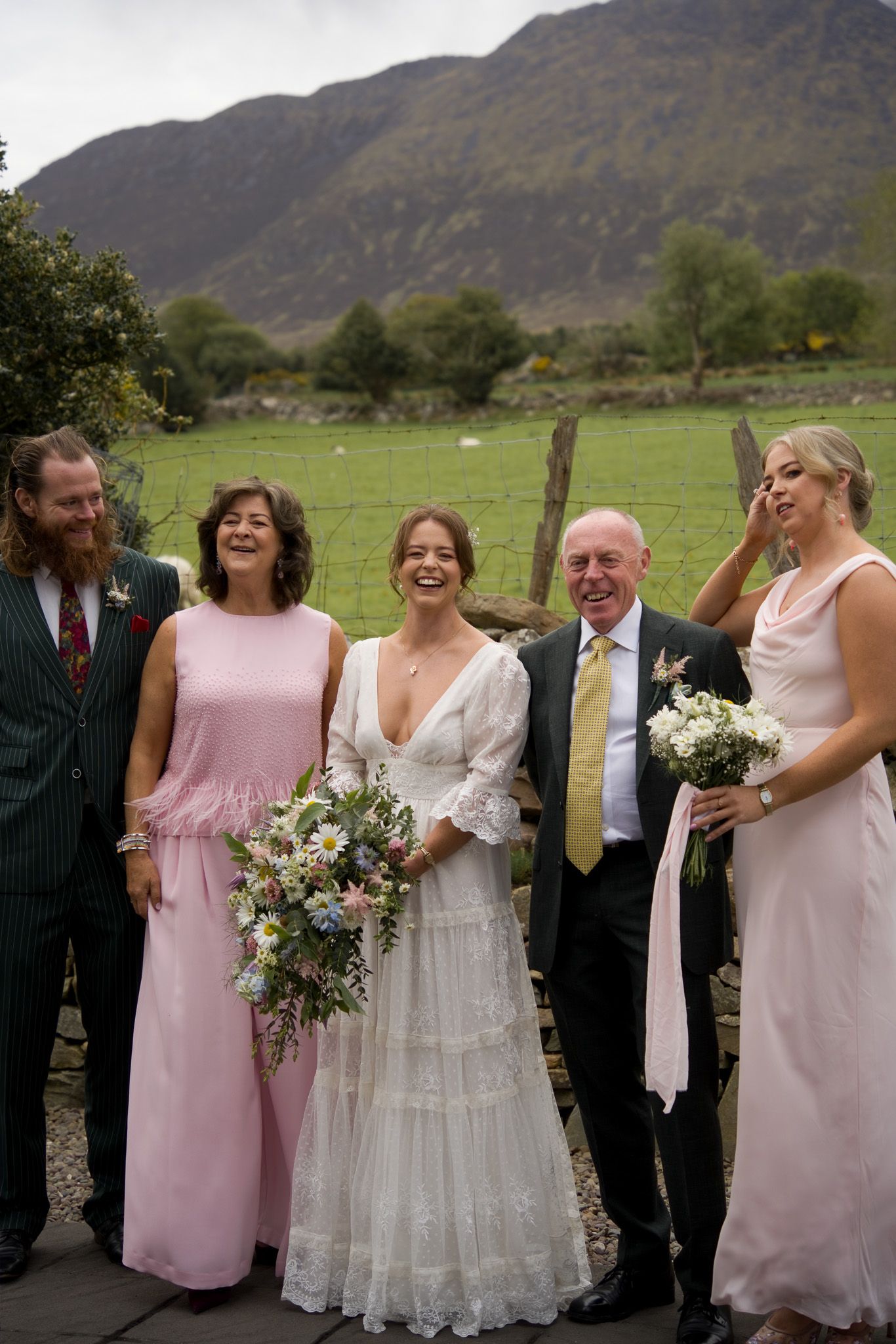 The bride and her family smiling together at a scenic rim wedding