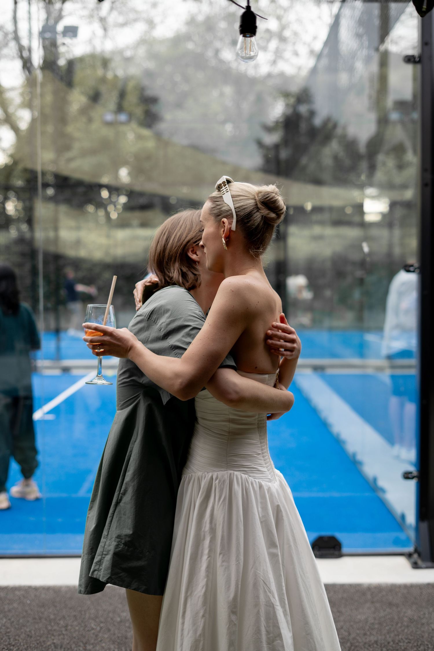 The sister of the groom and bride having a quiet moment together at a Brisbane wedding