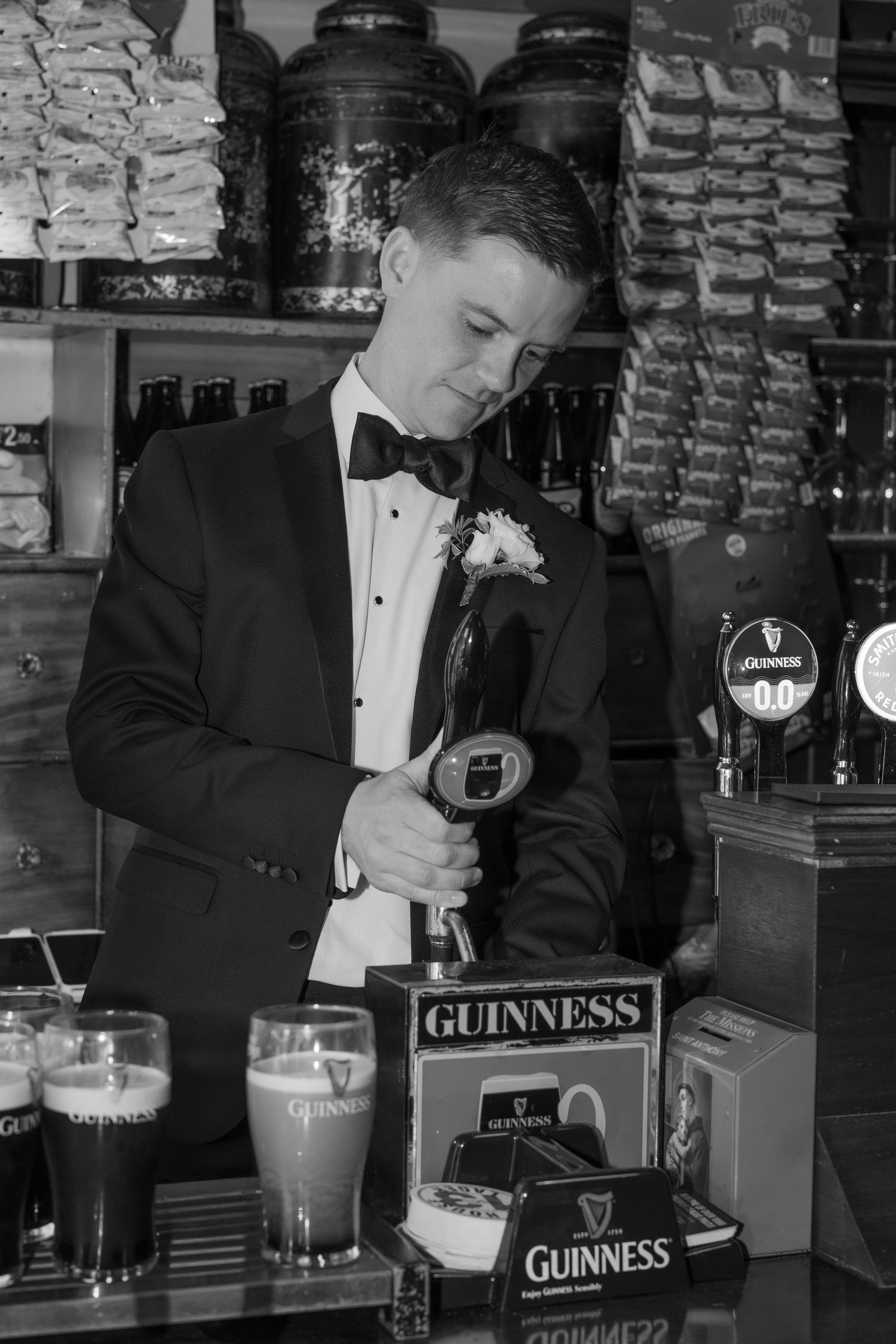 The groom pouring himself a pint before his wedding ceremony.