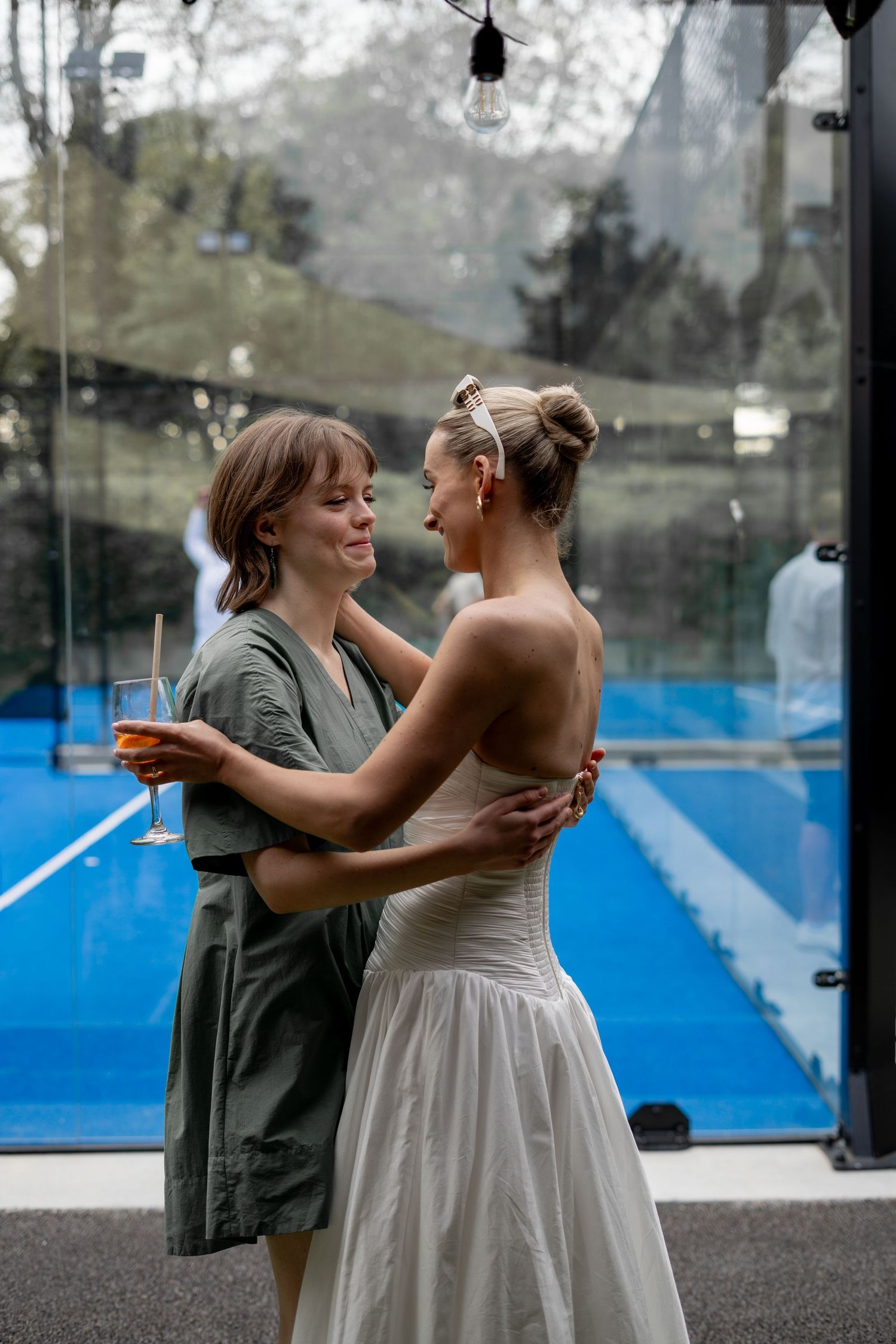 The sister of the groom and bride having a quiet moment together at a Brisbane wedding