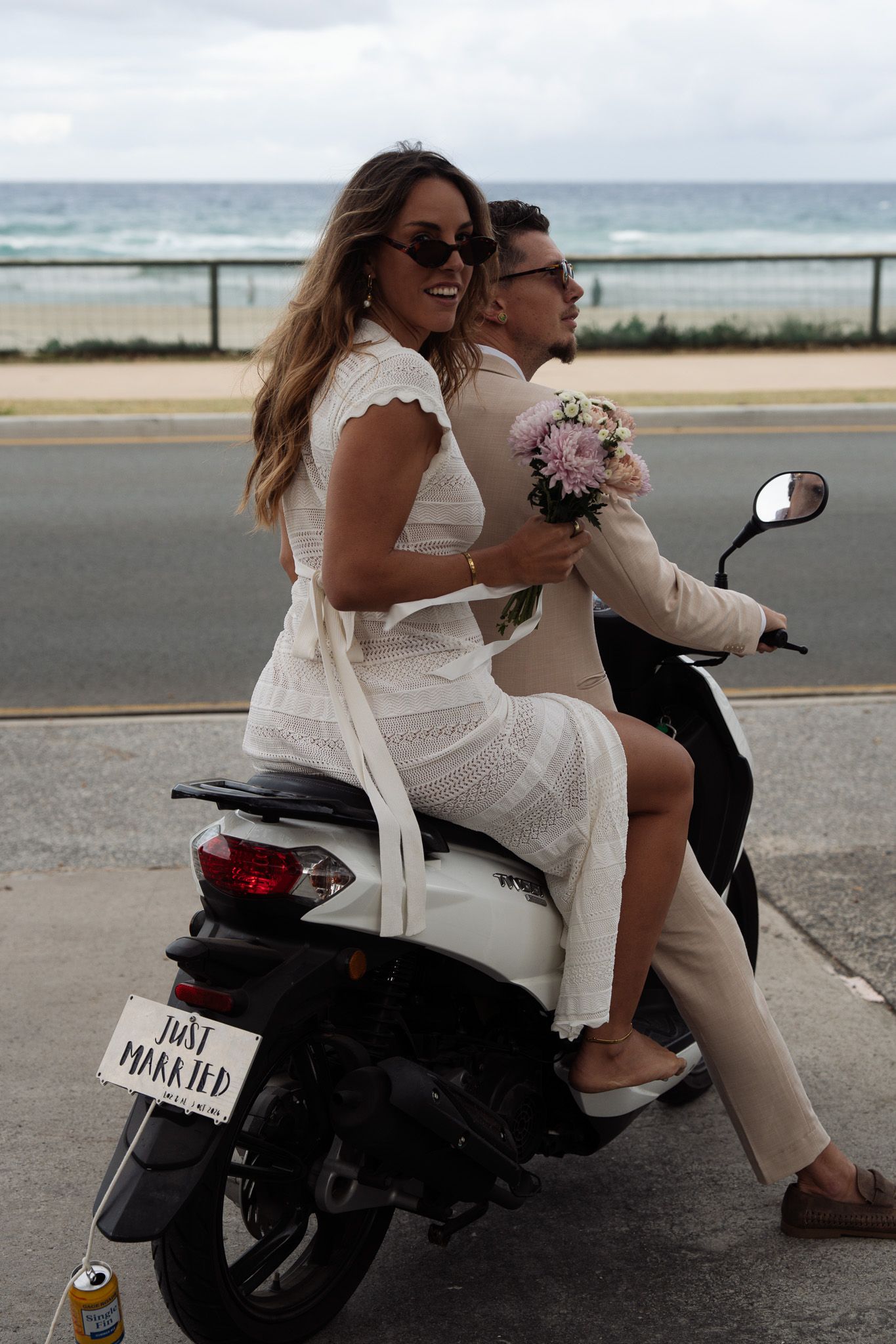 Bride and groom riding on motorbike after getting eloped on the Gold Coast