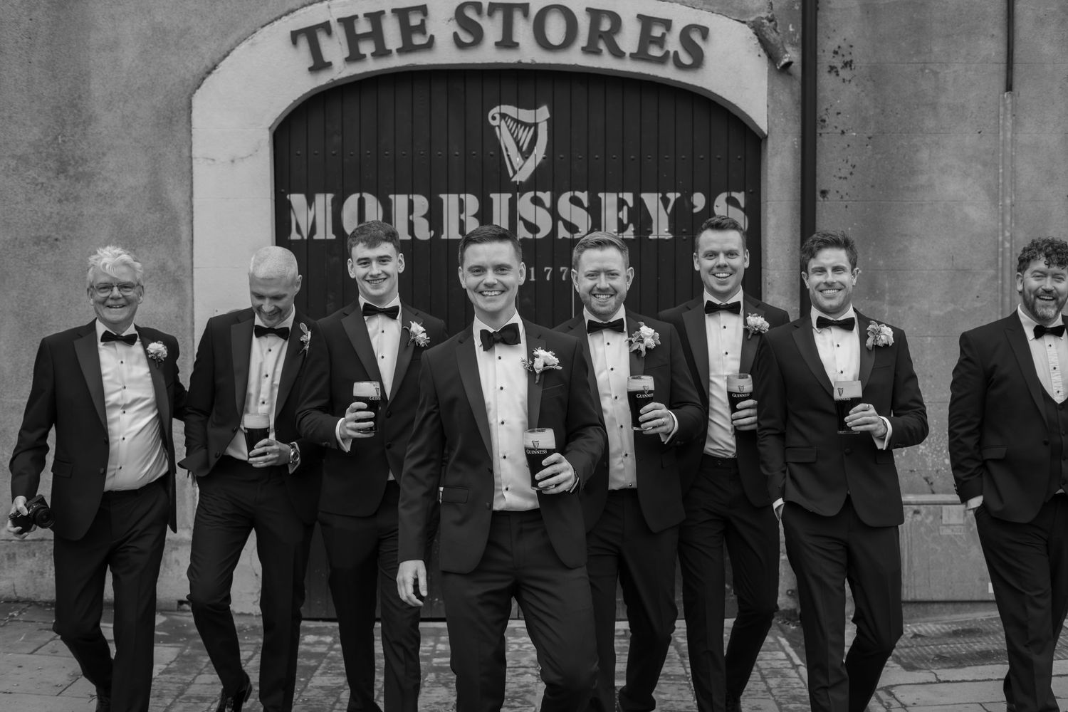 Groom and his groomsmen having a beer before the wedding ceremony
