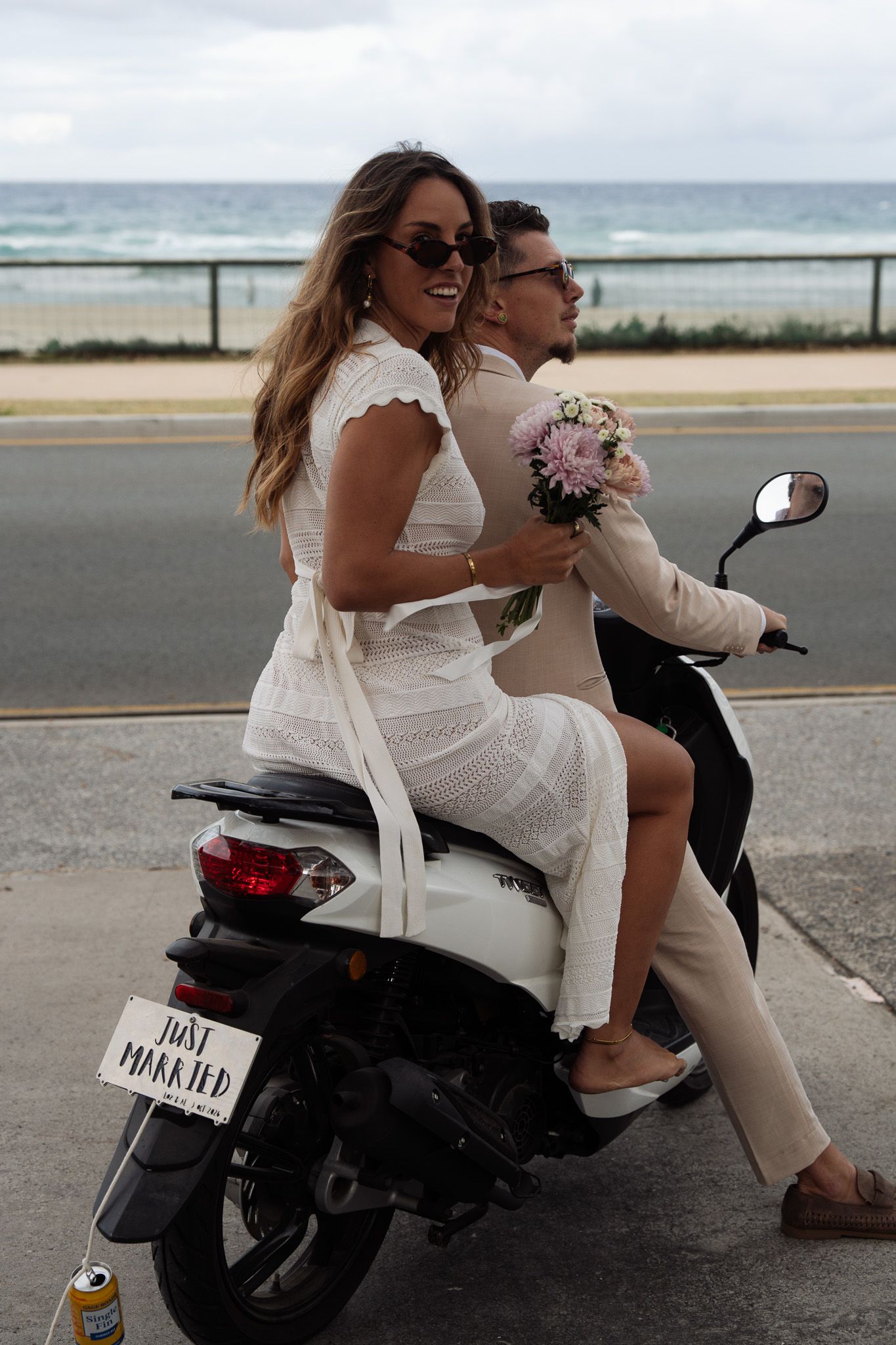 Bride and groom riding on motorbike after getting eloped on the Gold Coast