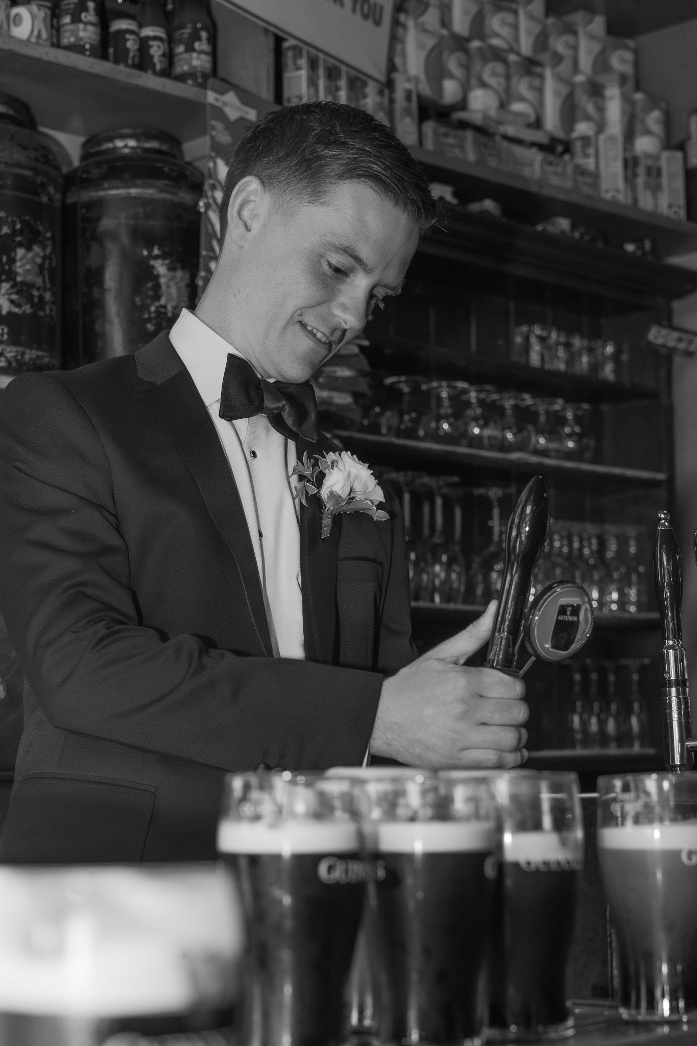 Groom pouring beer before Brisbane wedding
