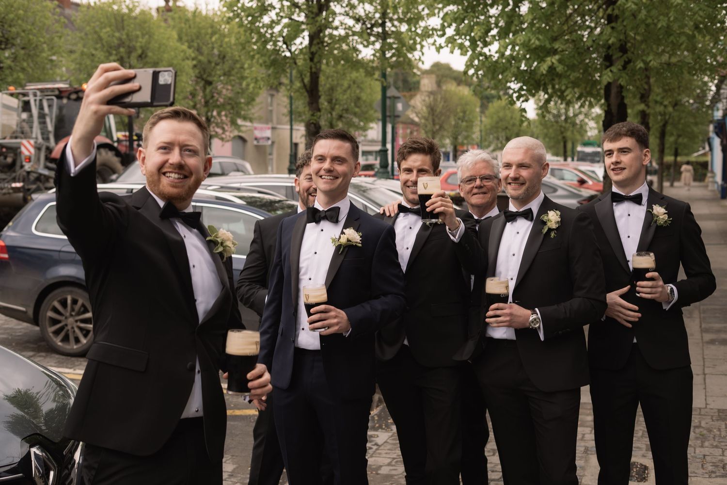 The groom and his groomsmen sharing a beer before the wedding
