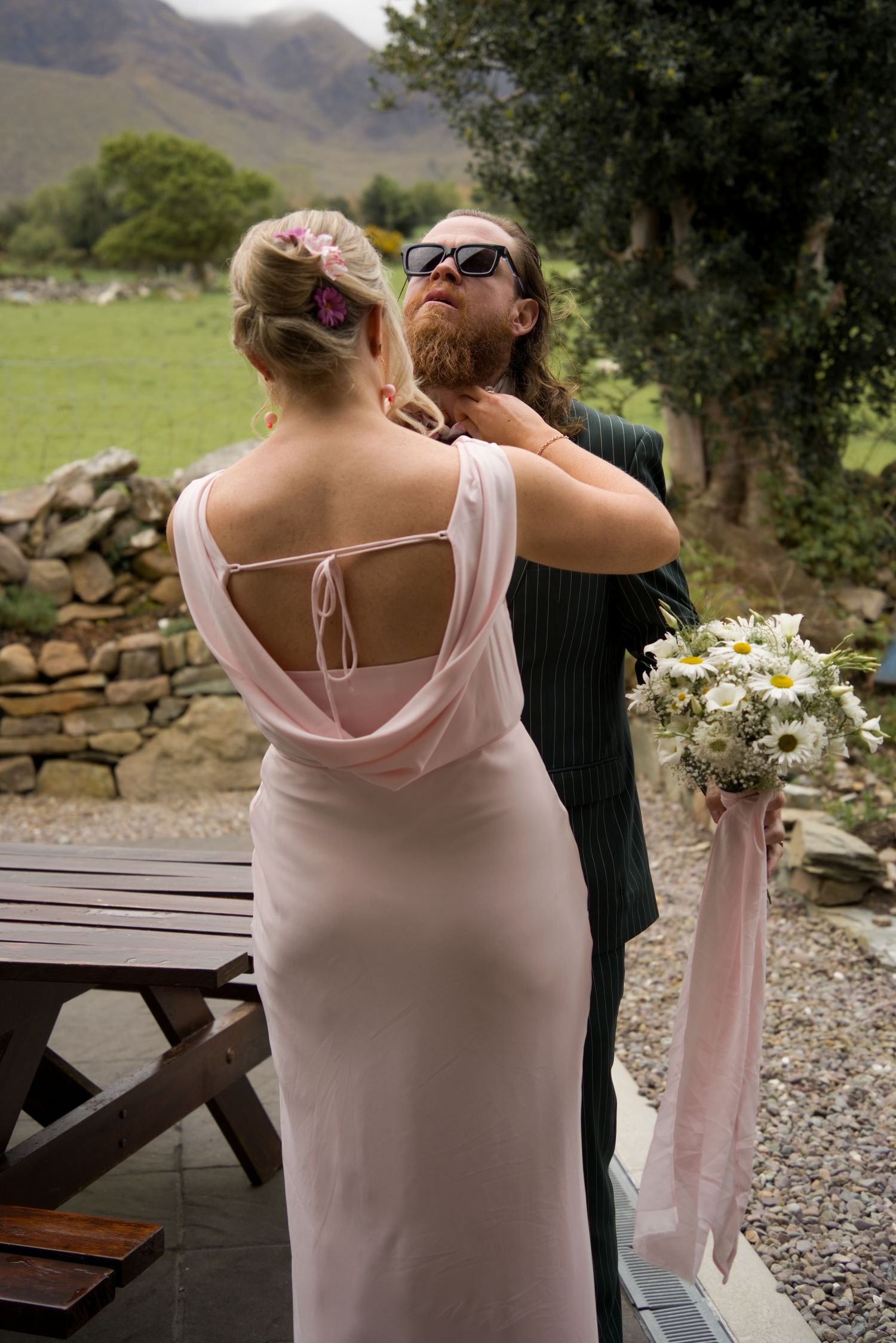 The maid of honour tying her brothers tie at a scenic rim wedding