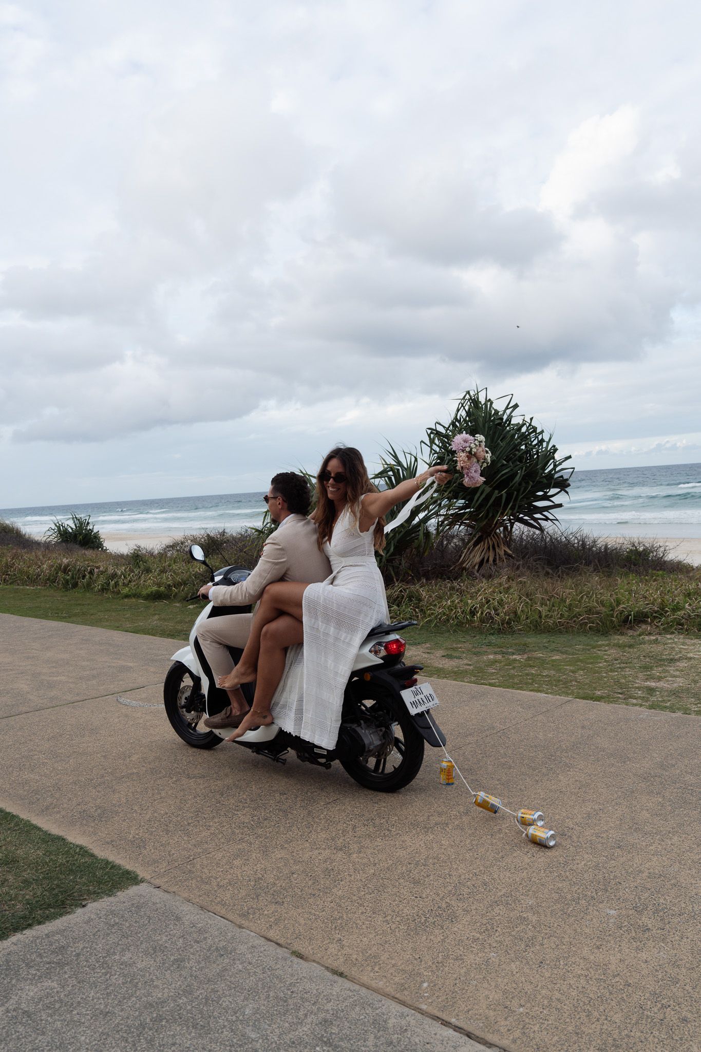 Bride and groom riding on motorbike after getting eloped on the Gold Coast
