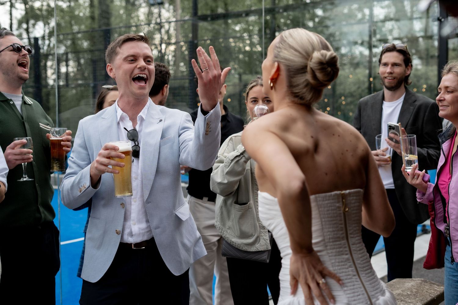 The groom showing off his wedding band to his bride