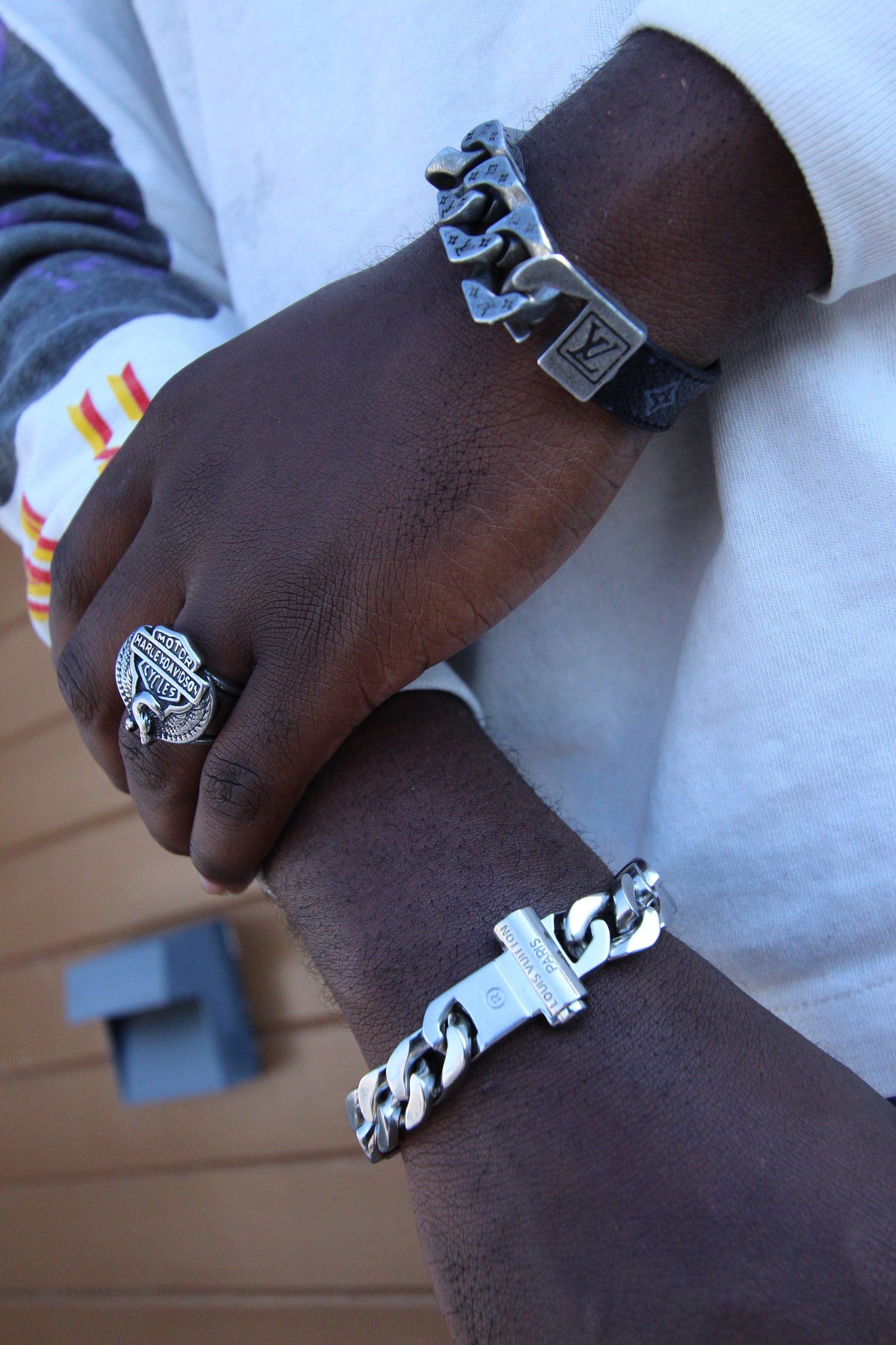 Close-up sequence showing someone wearing multiple silver rings and jewelry pieces on their hand against a white background.