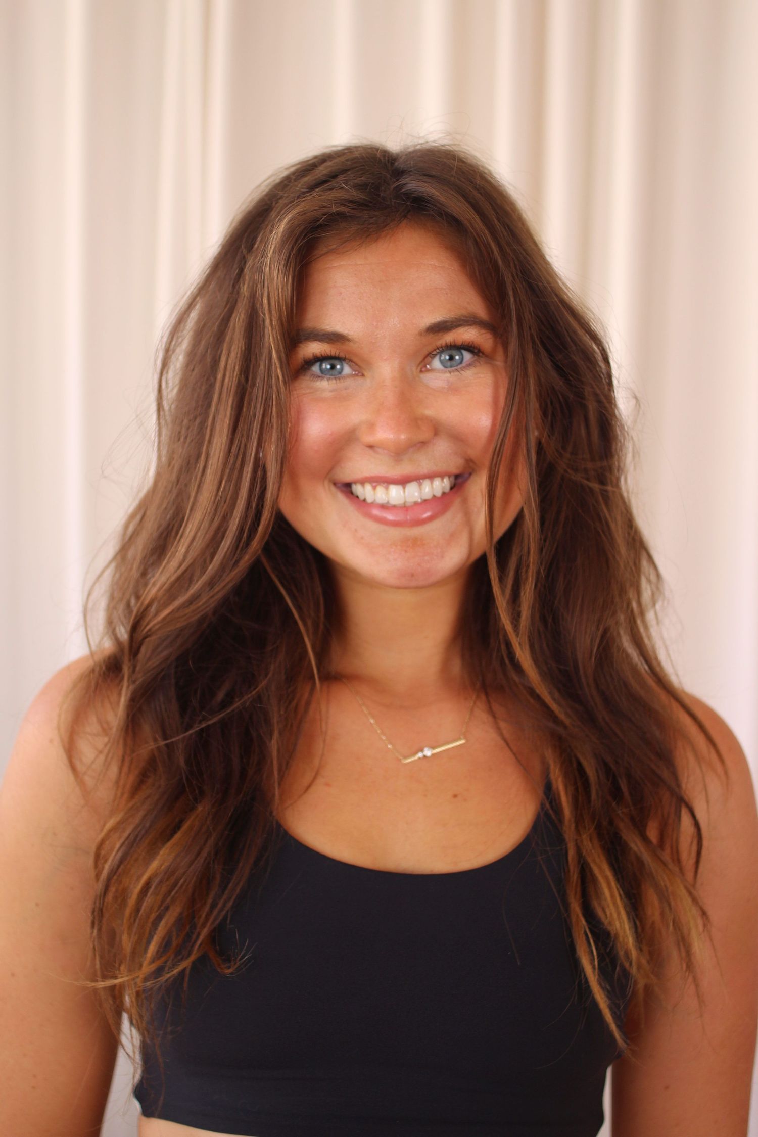 A series of four similar headshots showing someone with long brown hair wearing a black tank top against a light background.