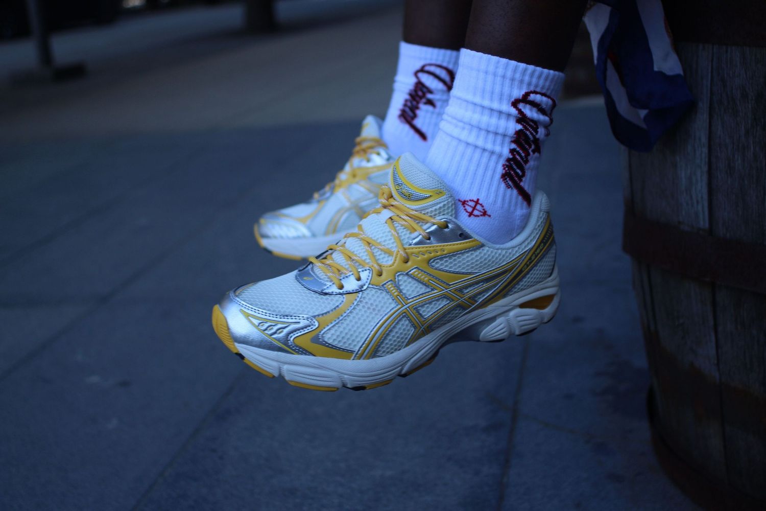 A sequence of close-up shots showing white and yellow athletic shoes on feet from different angles.