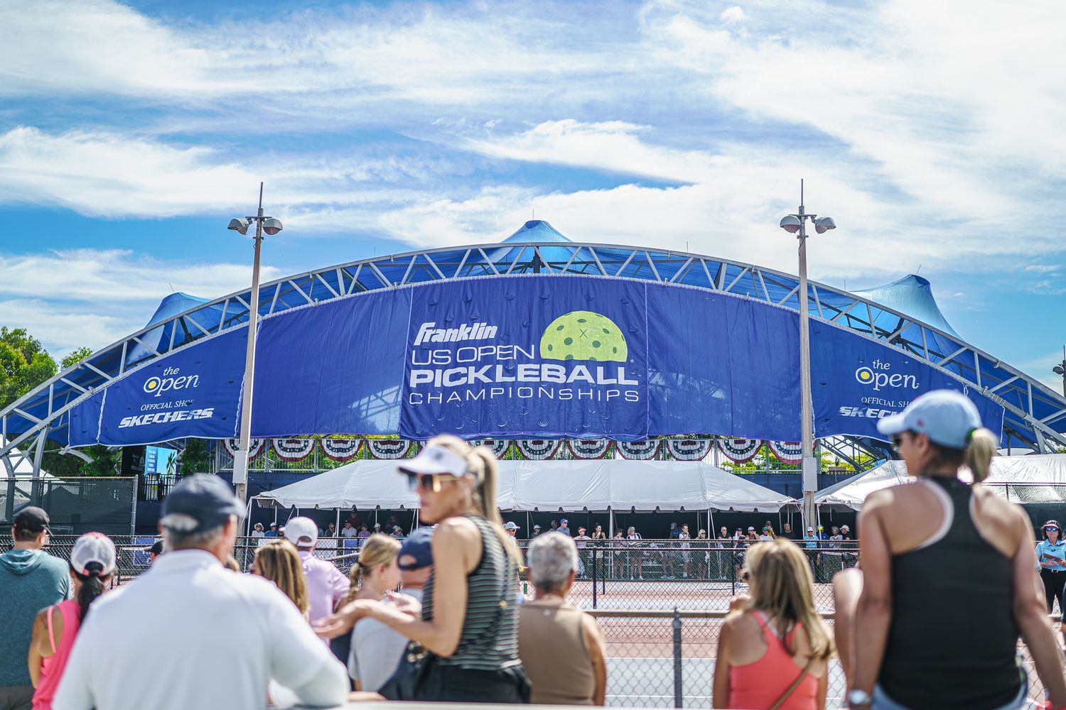 Crowd gathers outside the Franklin US Open Pickleball Championships arena on a sunny day.