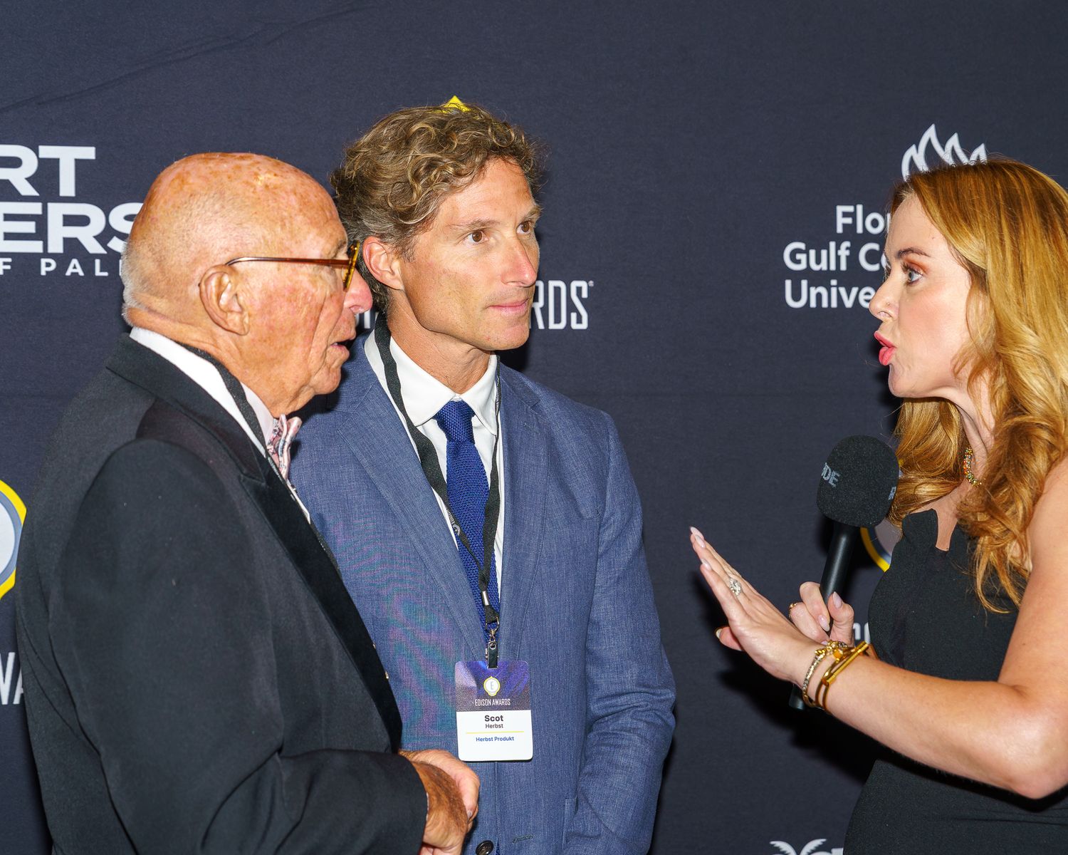 Reporter interviews two men at the 2026 Edison Awards
