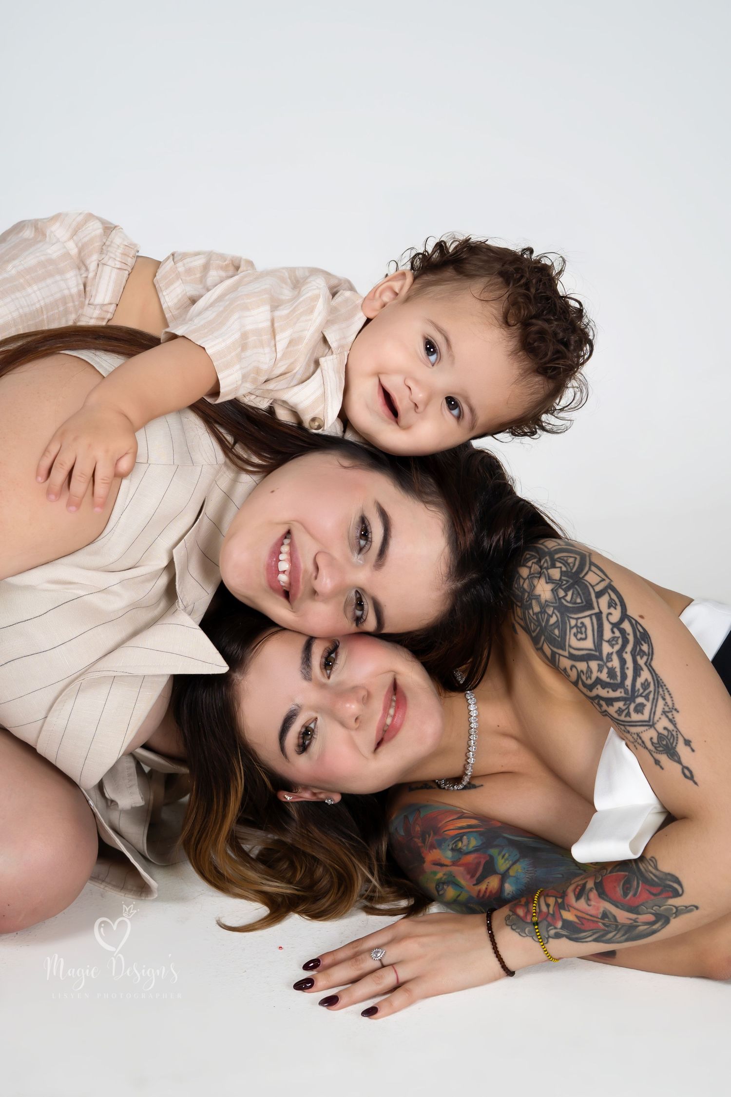 Simple white studio portrait capturing genuine smiles and joy.