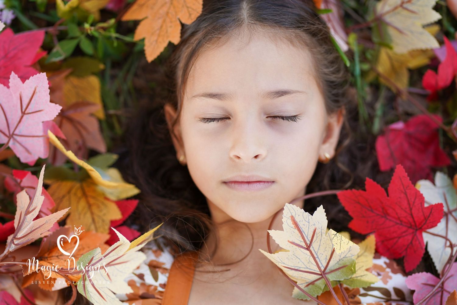 Autumn-themed portrait with colorful fall maple leaves creating a seasonal frame.