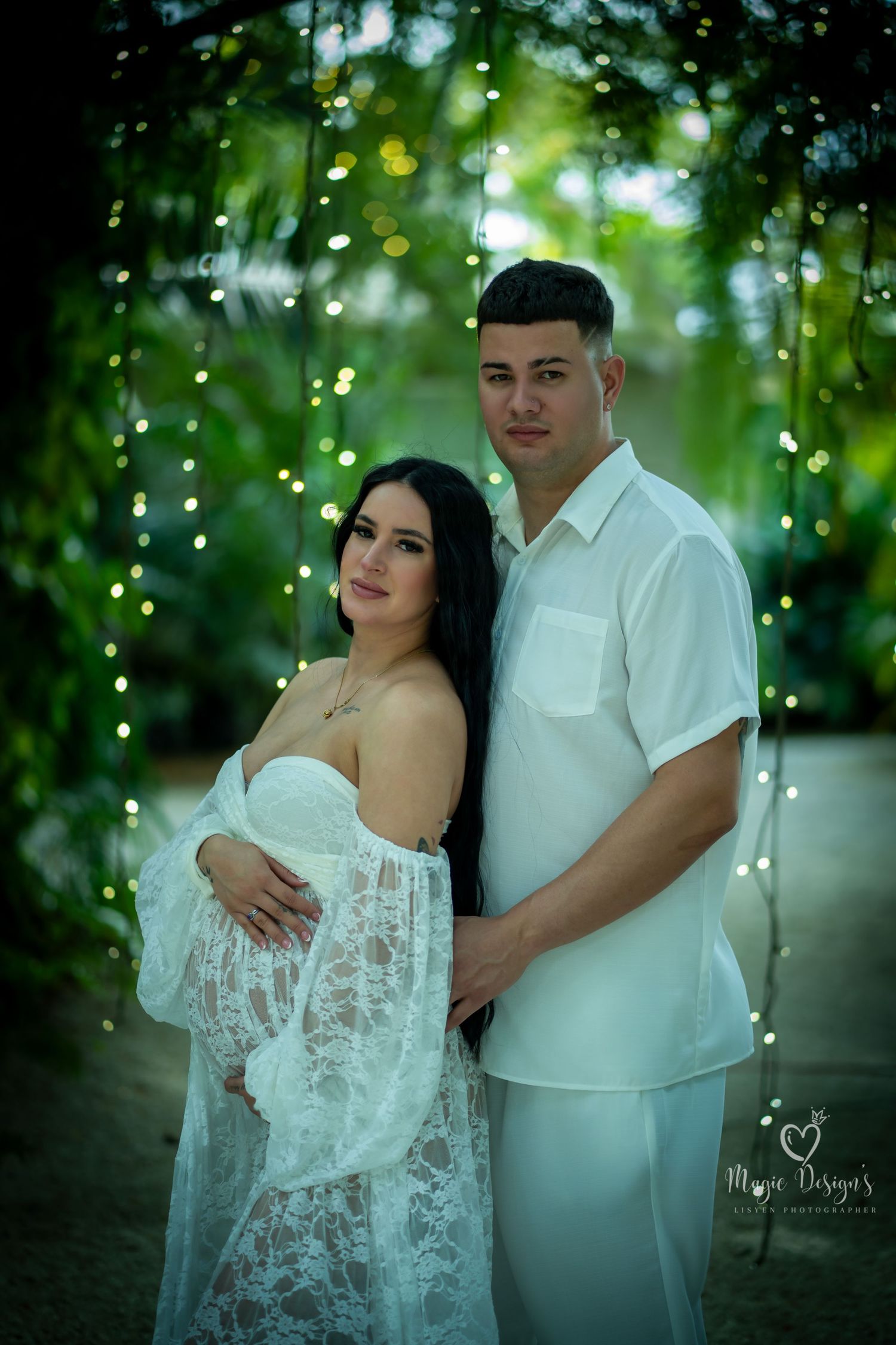 Romantic outdoor couple photoshoot with fairy lights and white lace dress.