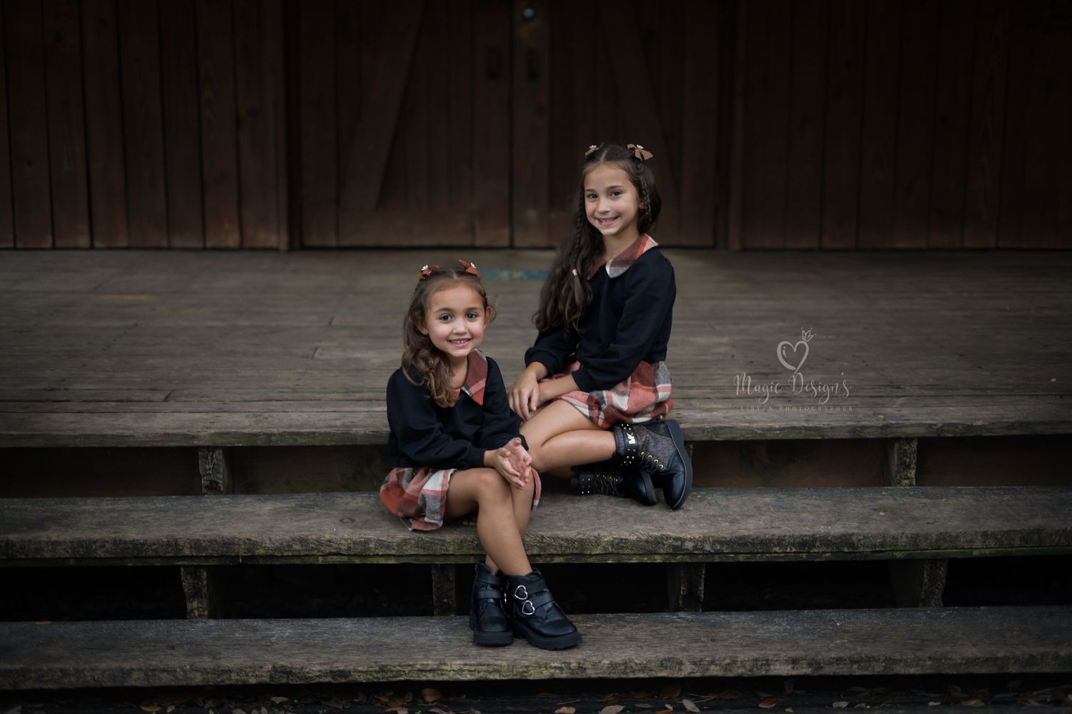 Candid moment captured on wooden steps with natural lighting and rustic backdrop.
