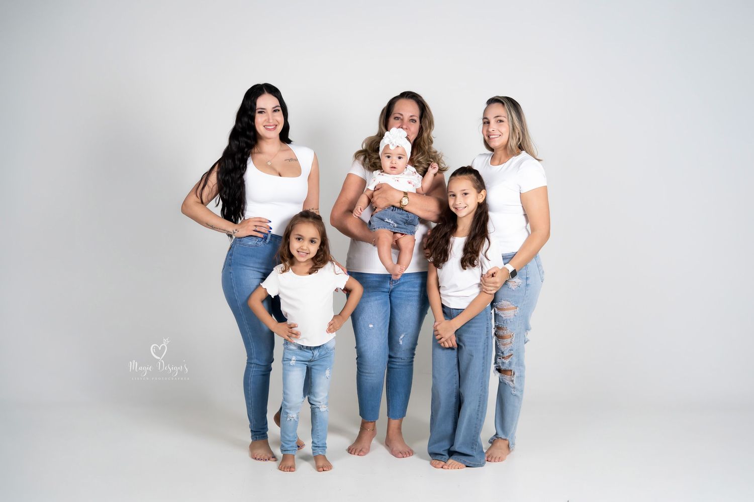 A series of casual family portrait poses against a white backdrop showing matching denim and white outfits.