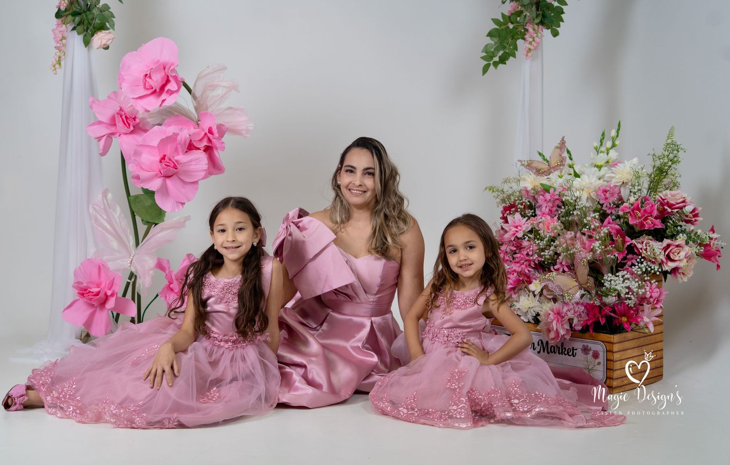 Beautiful portrait setup with coordinated pink gowns and floral arrangements.