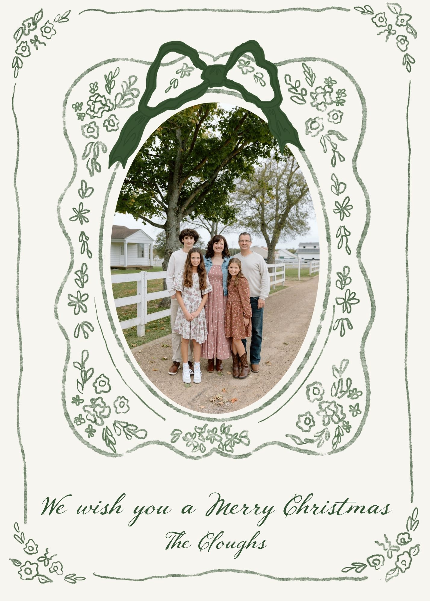 Family Christmas card with oval photo frame, floral border, green bow, and cursive text reading We wish you a Merry Christmas, The Cloughs.