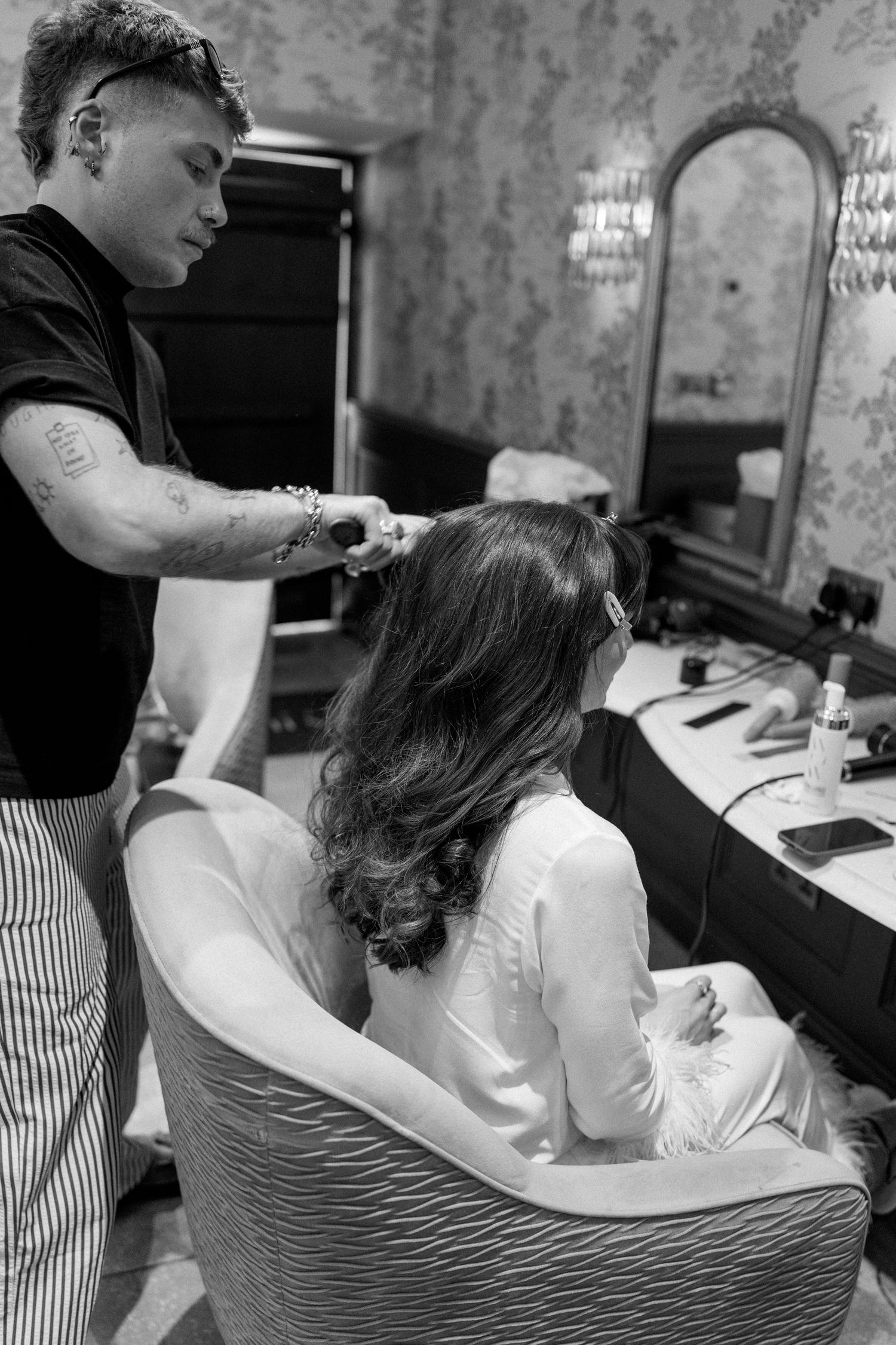 Hair styling session in progress at salon with stylist working on client.