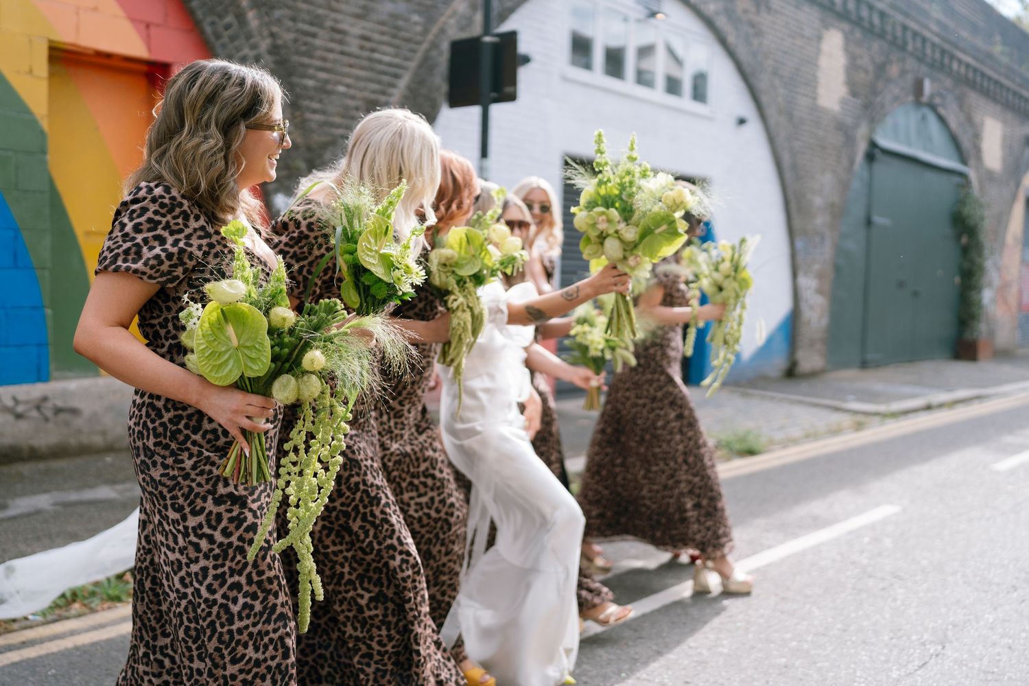 Wedding celebration in an urban setting with guests mingling outdoors.