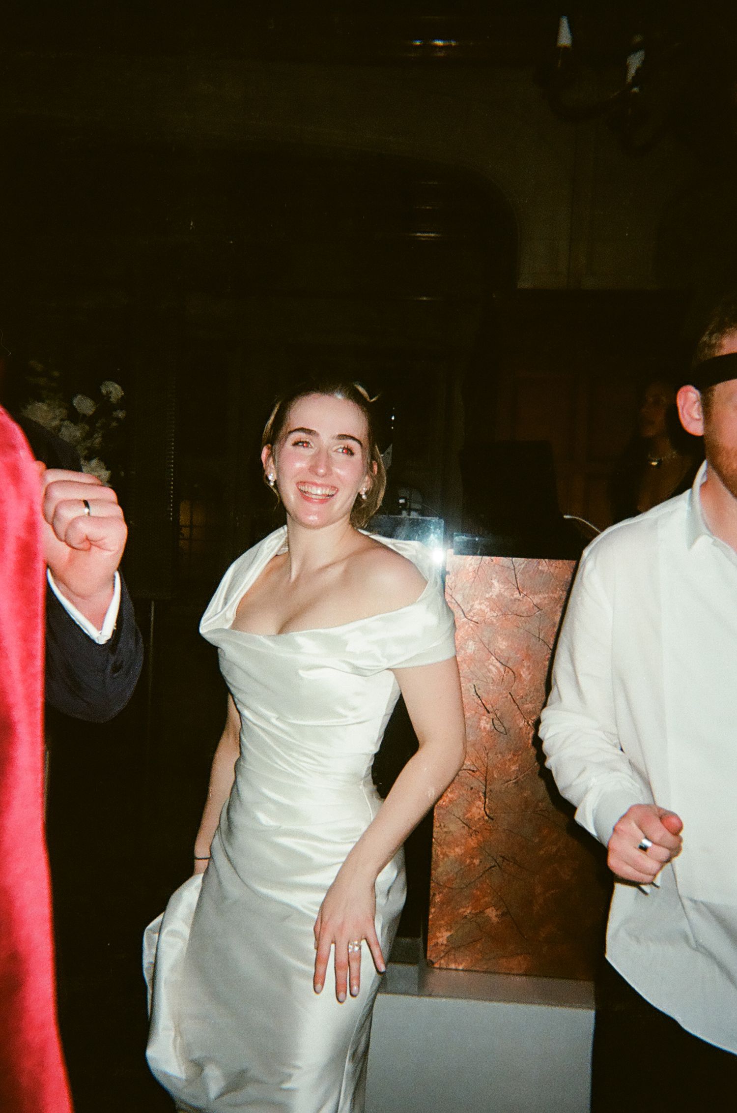 Wedding celebration scene with people dancing and moving in formal attire.