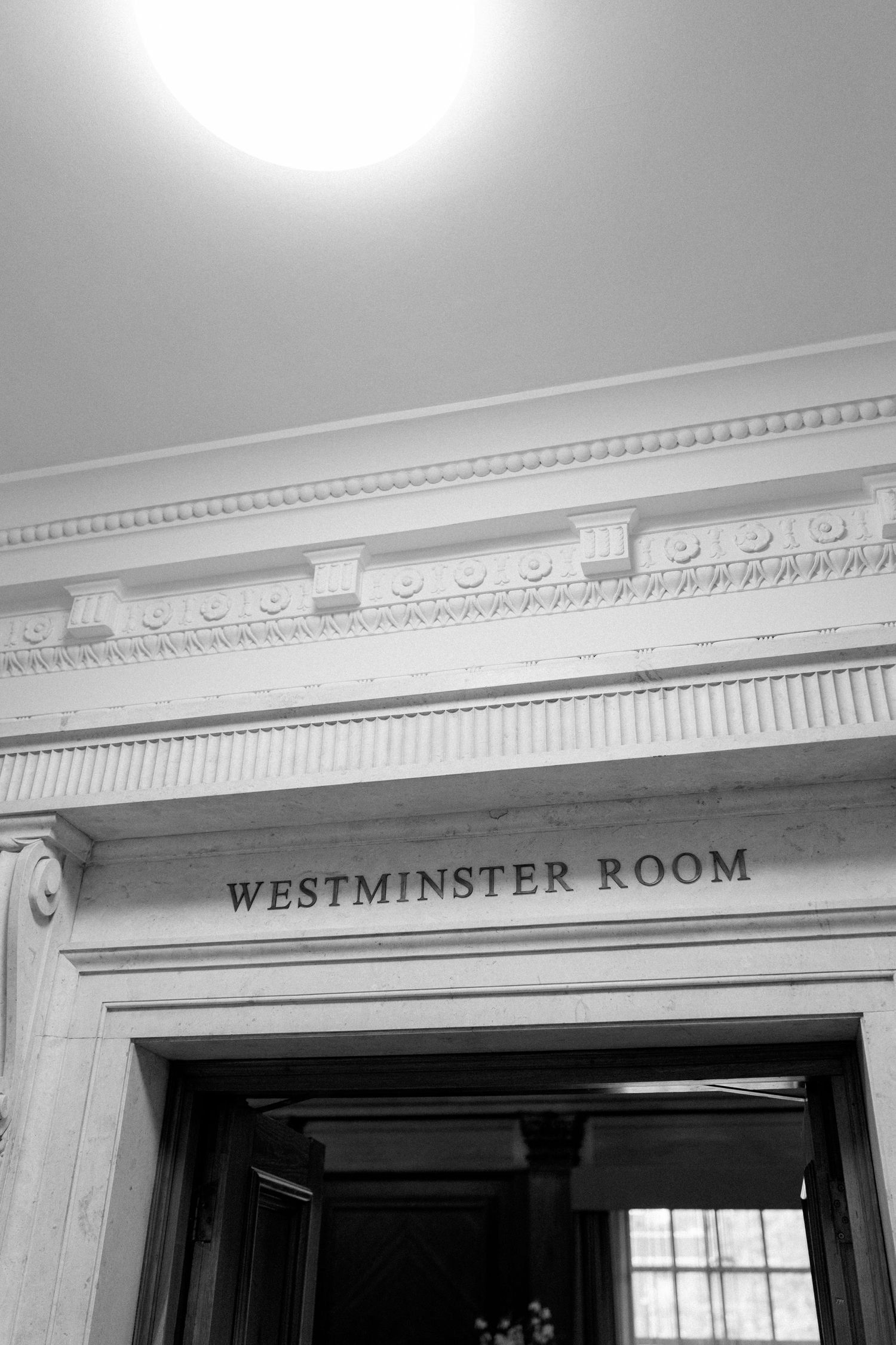Classic architectural detail showing 'Westminster Room' signage with ornate crown molding and trim.